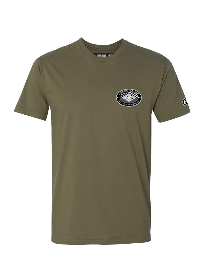 The Pedro Sauer Leverage T-Shirt in military green features short sleeves, a small mountain-themed patch on the left chest, and a circular logo on the left sleeve. Displayed against a plain white background.