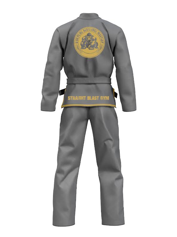 The SBG DRM Suparaito BJJ GI Gray is shown from the back, with a yellow circular logo on the upper back and "STRAIGHT BLAST GYM" in yellow across the lower back of the jacket.