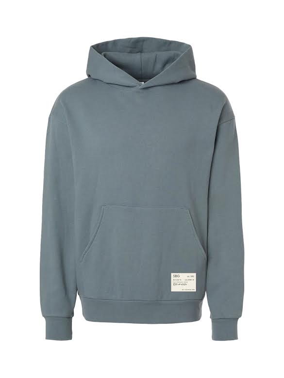 The SBG Roll With Intention Hoodie Blue is a plain, blue-gray hoodie with a front pocket, long sleeves, ribbed cuffs and hem, and a small white rectangular label near the lower left hem.