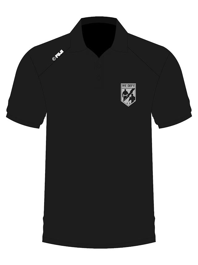 We Defy Performance Polo Black, a short-sleeved polo with a logo on the right shoulder and a shield-shaped chest patch reading WE DEFY FOUNDATION above two grappling figures.