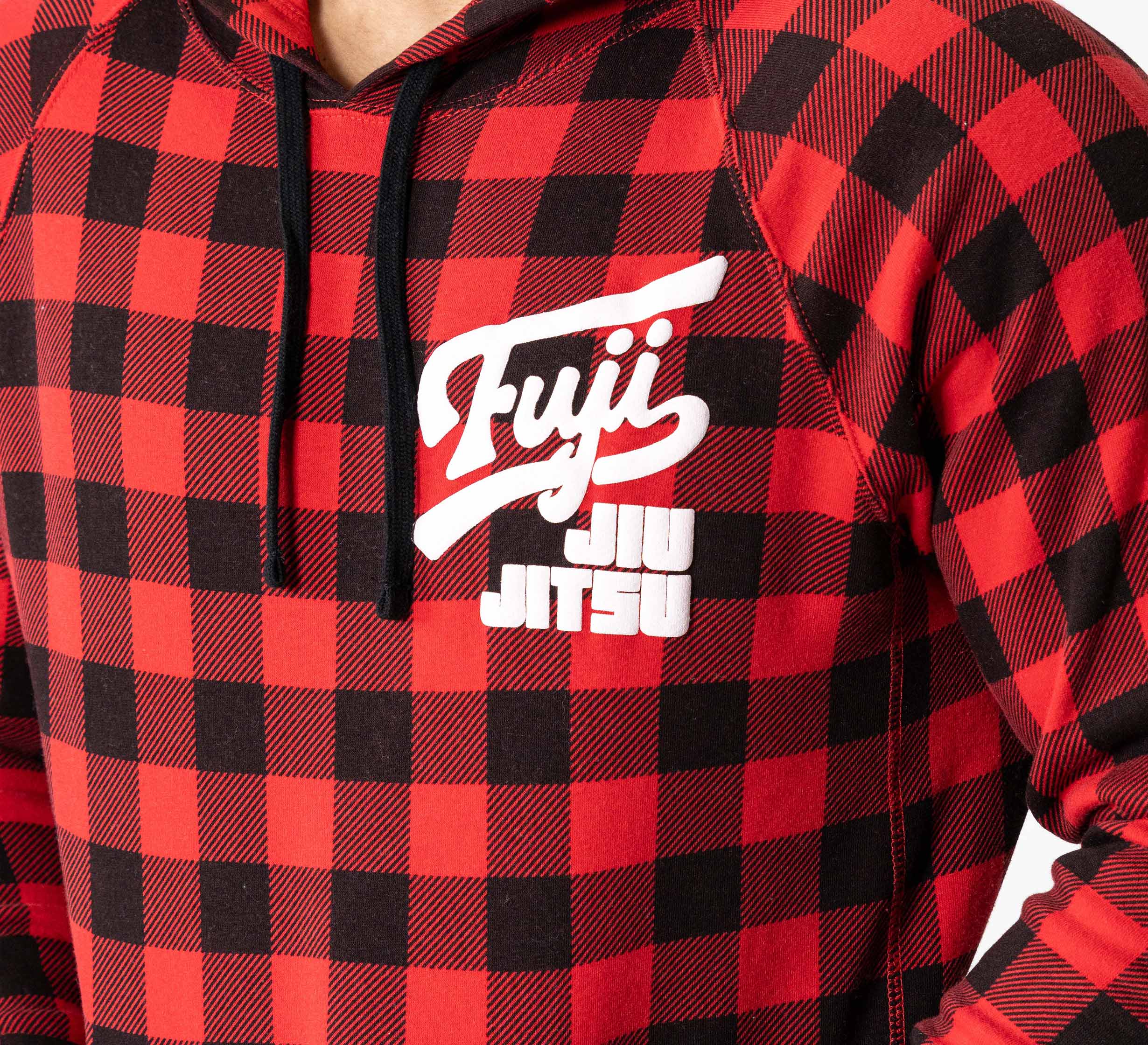 A person wearing the Signature Hoodie Red Plaid, featuring bold white "Fuji Jiu Jitsu" text on the chest.
