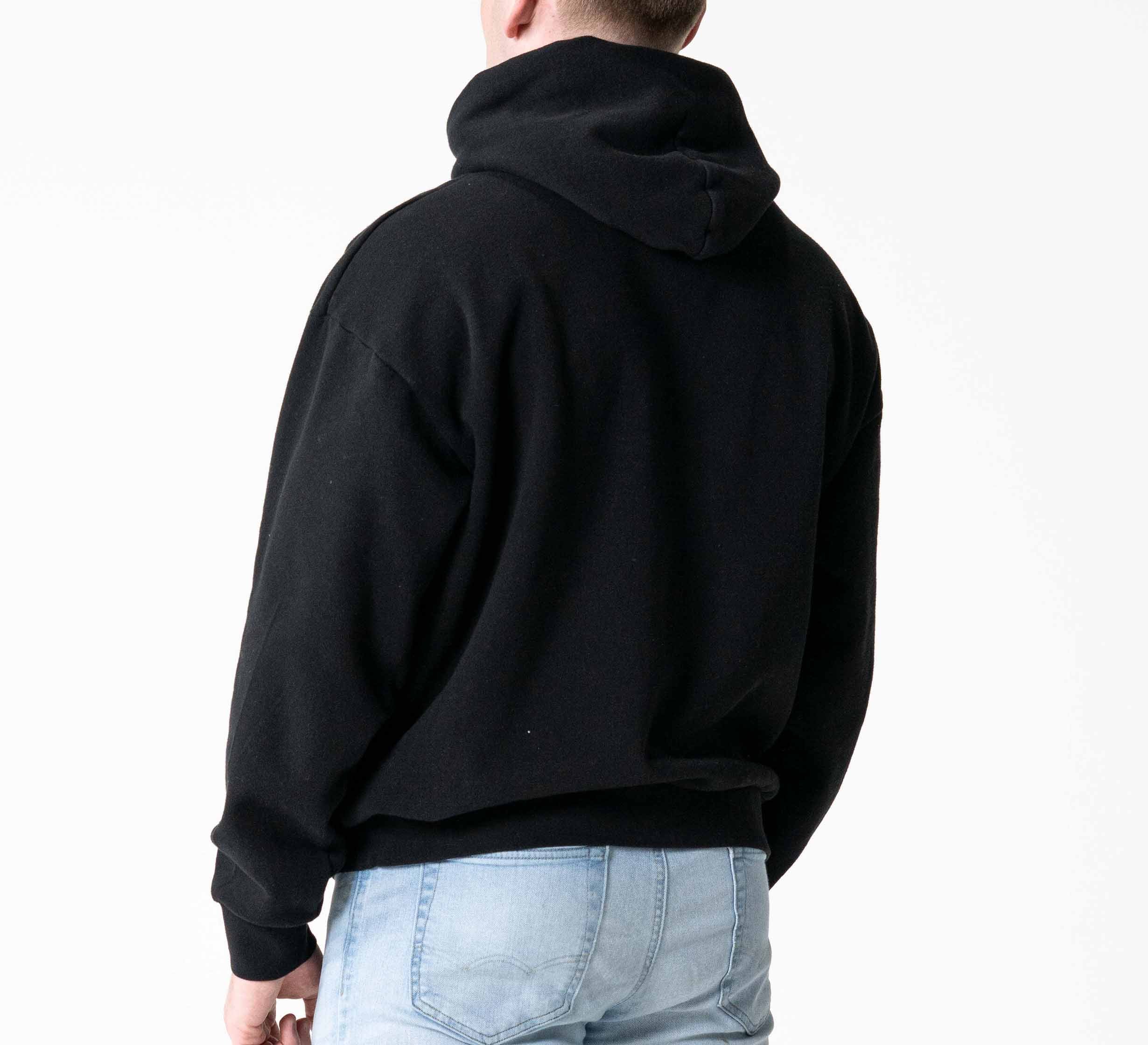 A person is shown from the back against a plain white background, wearing the Signature Hoodie Black and light blue jeans.