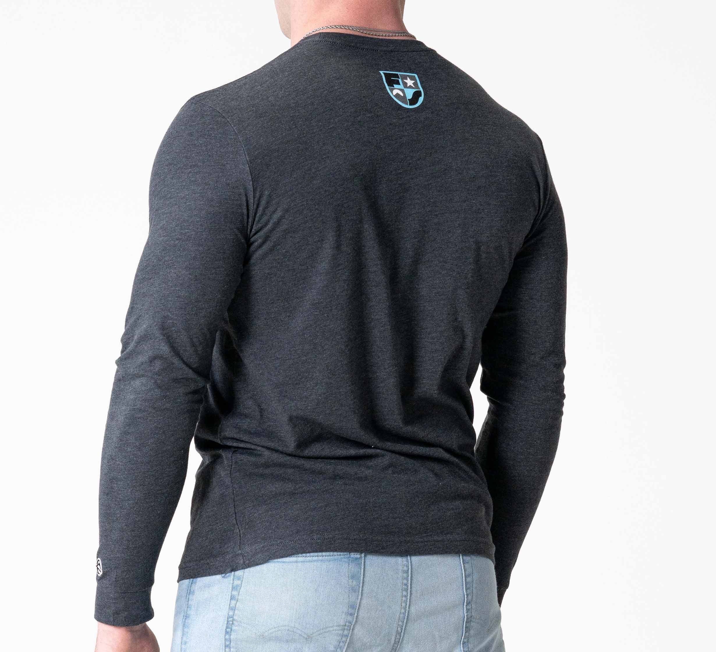 Someone is shown from behind in a Retro Long Sleeve Shirt Charcoal with a small upper-back logo and light blue jeans, set against a plain white background.