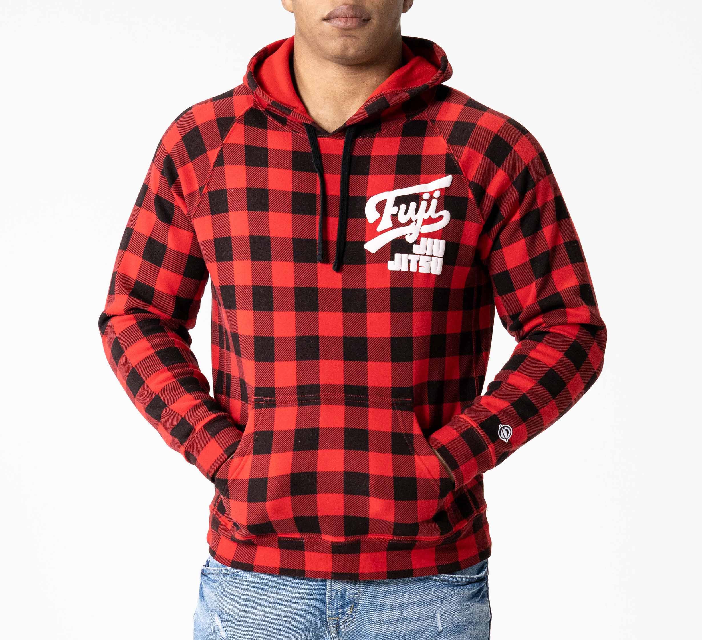 A person wearing the Signature Hoodie Red Plaid with "Fuji Jiu Jitsu" in white on the chest and light blue jeans, standing against a plain white background.