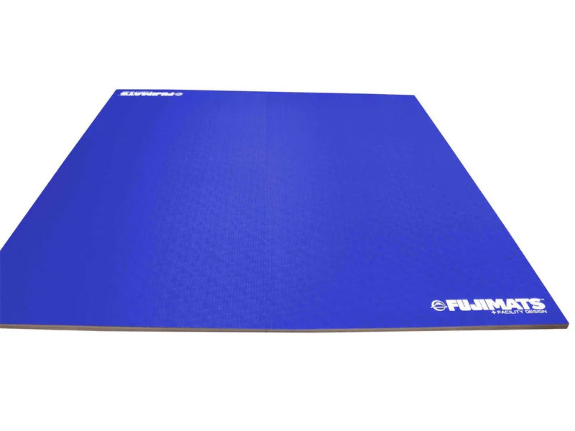 The Home Roll Out Mat Tatami Series Blue is a large, flat, rectangular blue mat with "FUJI MATS Facility Edition" printed in white at two corners, designed for athletic or martial arts use.