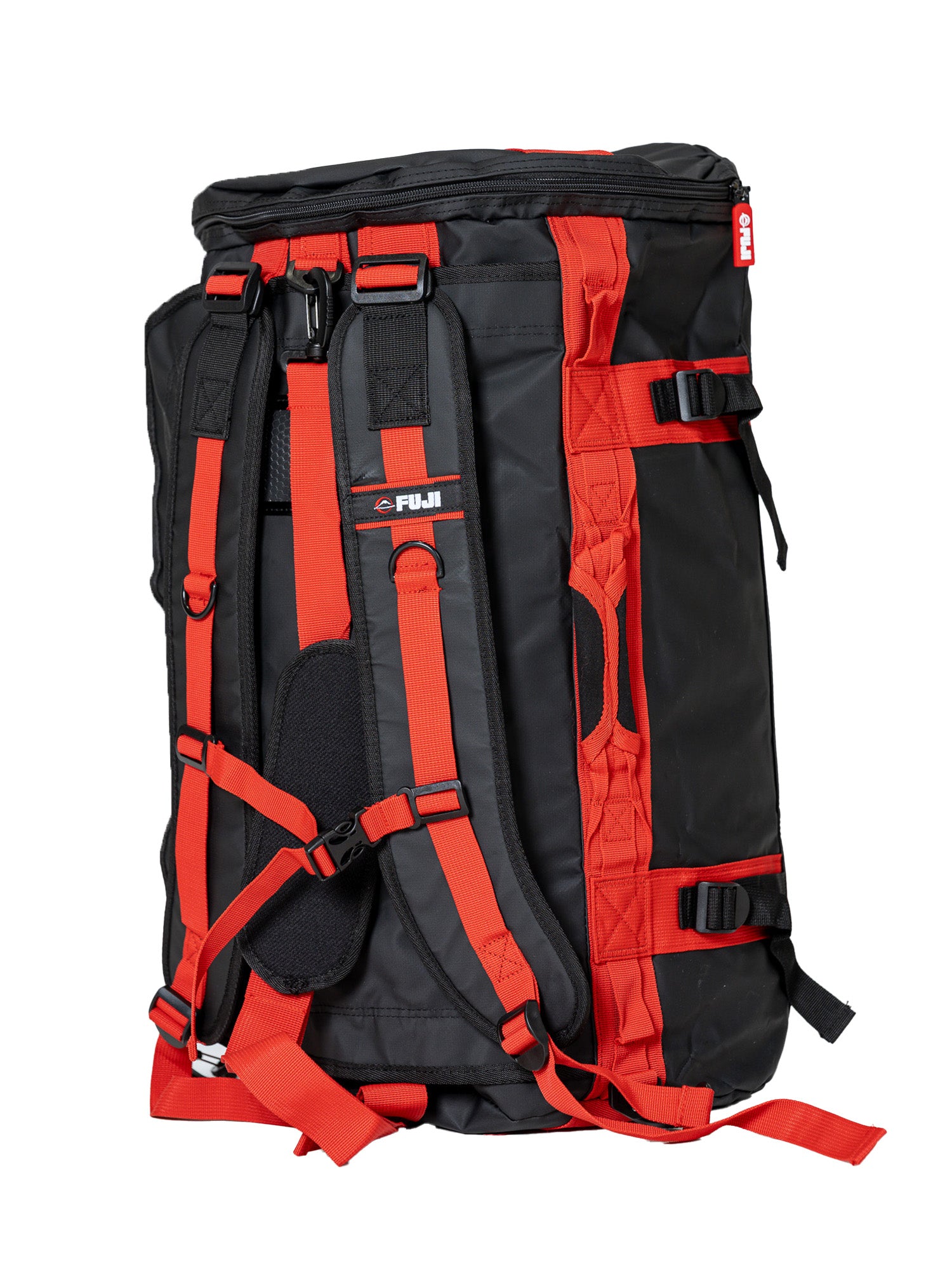 The Comp Duffle Black Red backpack, featuring padded shoulder straps, multiple buckles, adjustment straps, and a top handle, is shown upright on a white background.