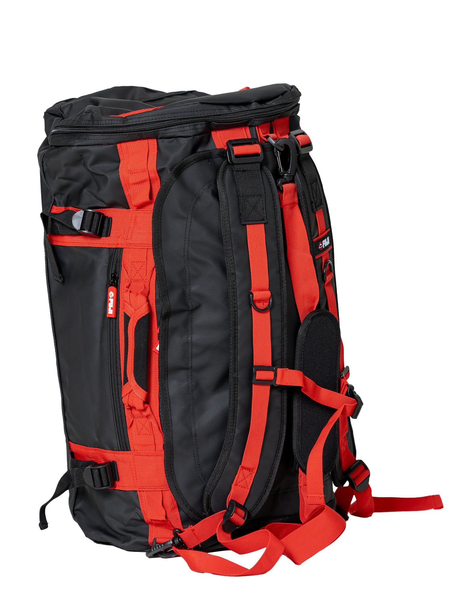 The Comp Duffle Black Red is a duffel-style backpack in black and red, featuring multiple straps, handles, and buckles, displayed upright against a white background.