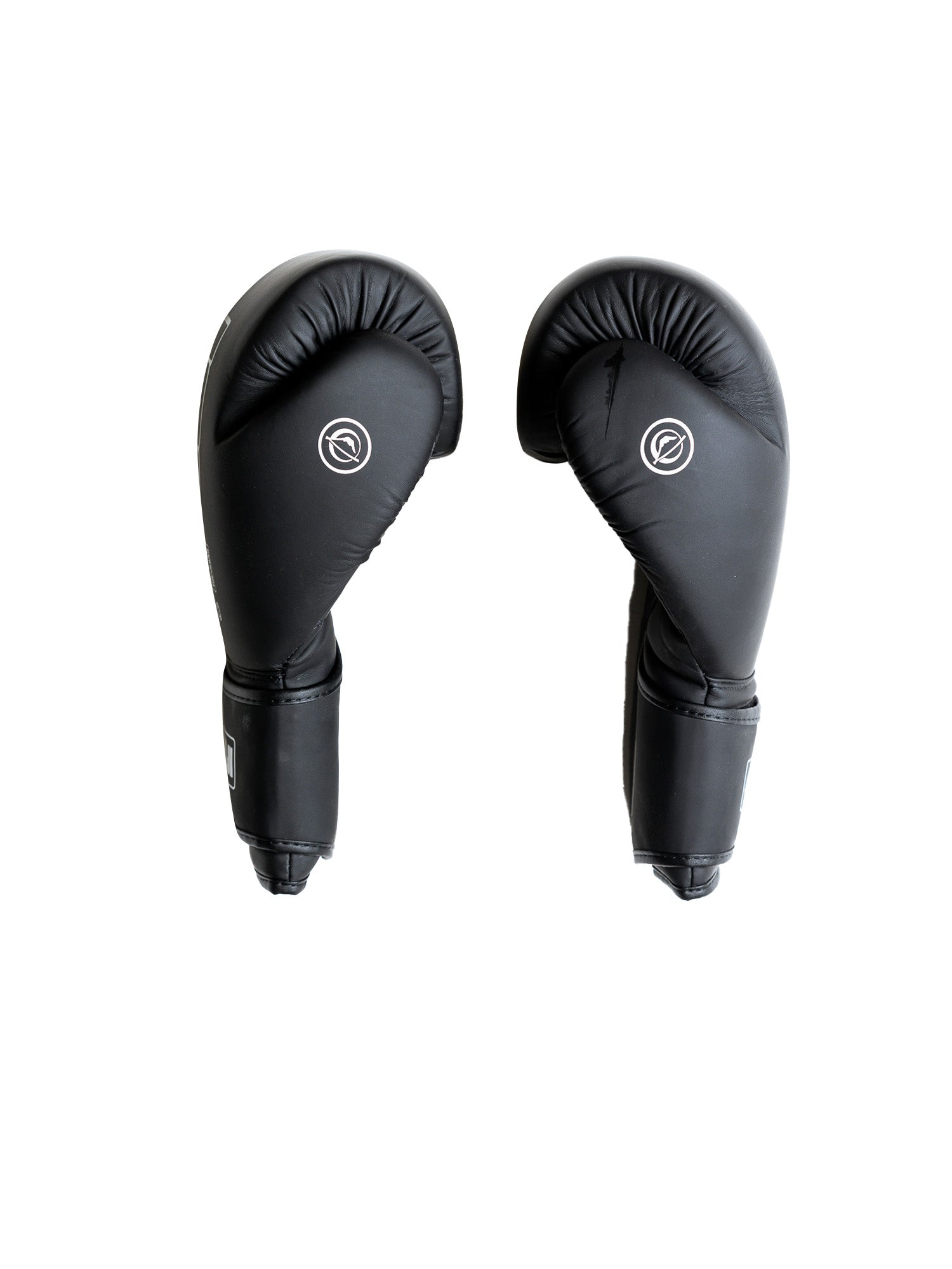 The Baseline Boxing Glove Black is shown upright with thumbs facing inward on a white background, featuring a simple white logo on the top.