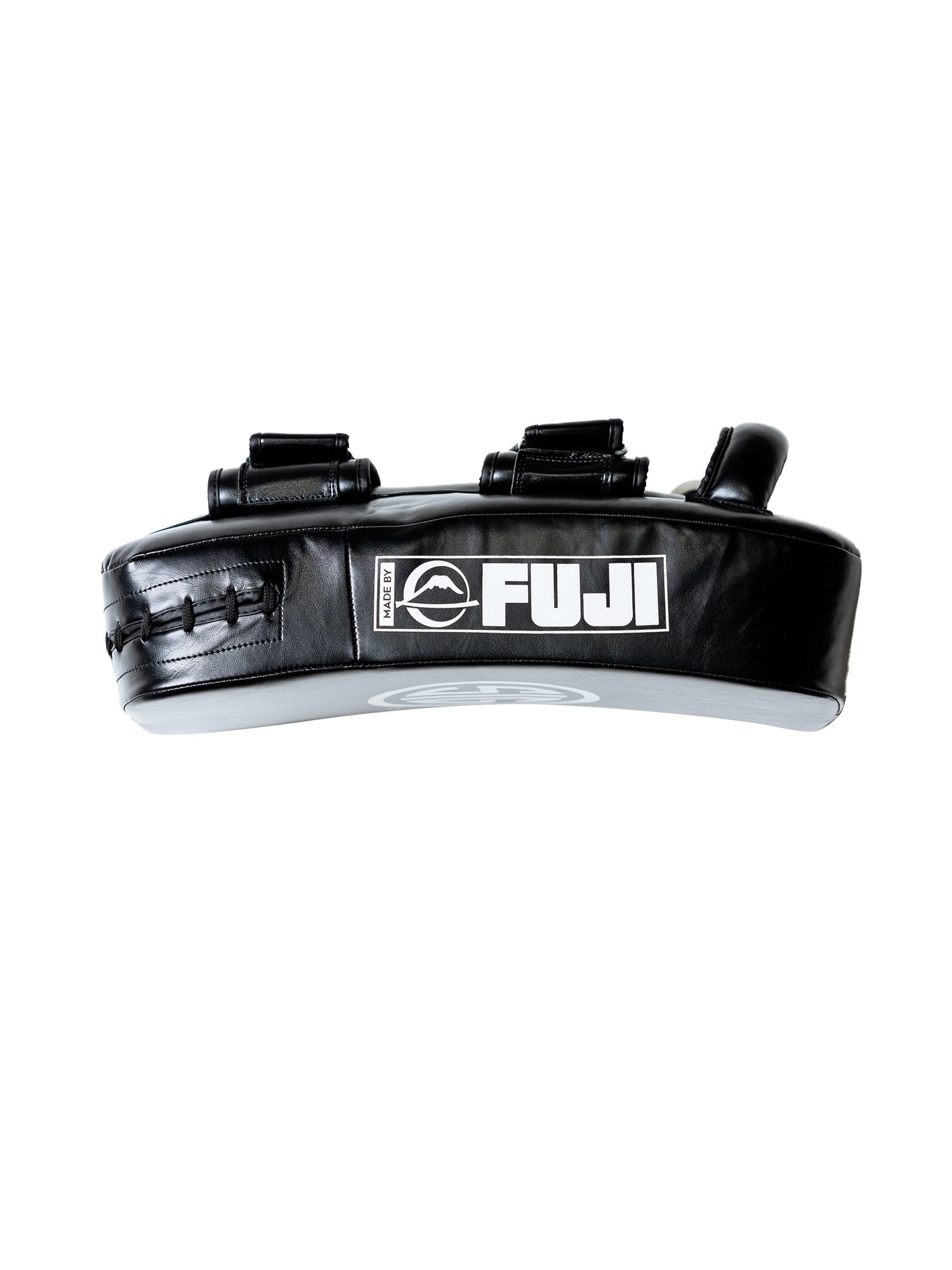 The Sig Sauer Thai Pads are black, curved kick pads with two handles and a white FUJI logo on the front, made from durable material for martial arts training.