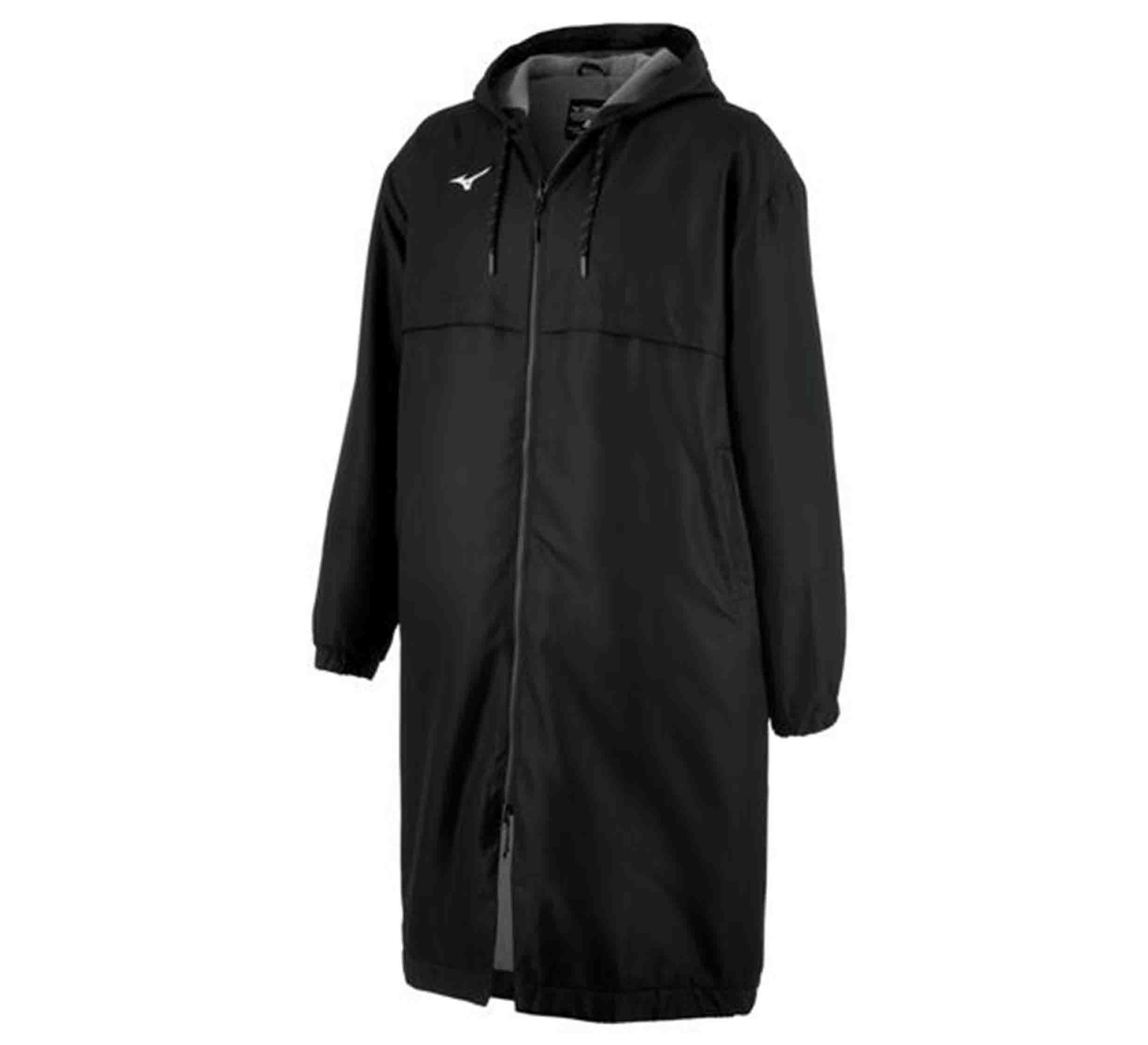 The Mizuno Team Parka Black is a long, loose-fit black coat with a hood, front zipper, elastic cuffs, a small white chest logo, and extends below the knees.