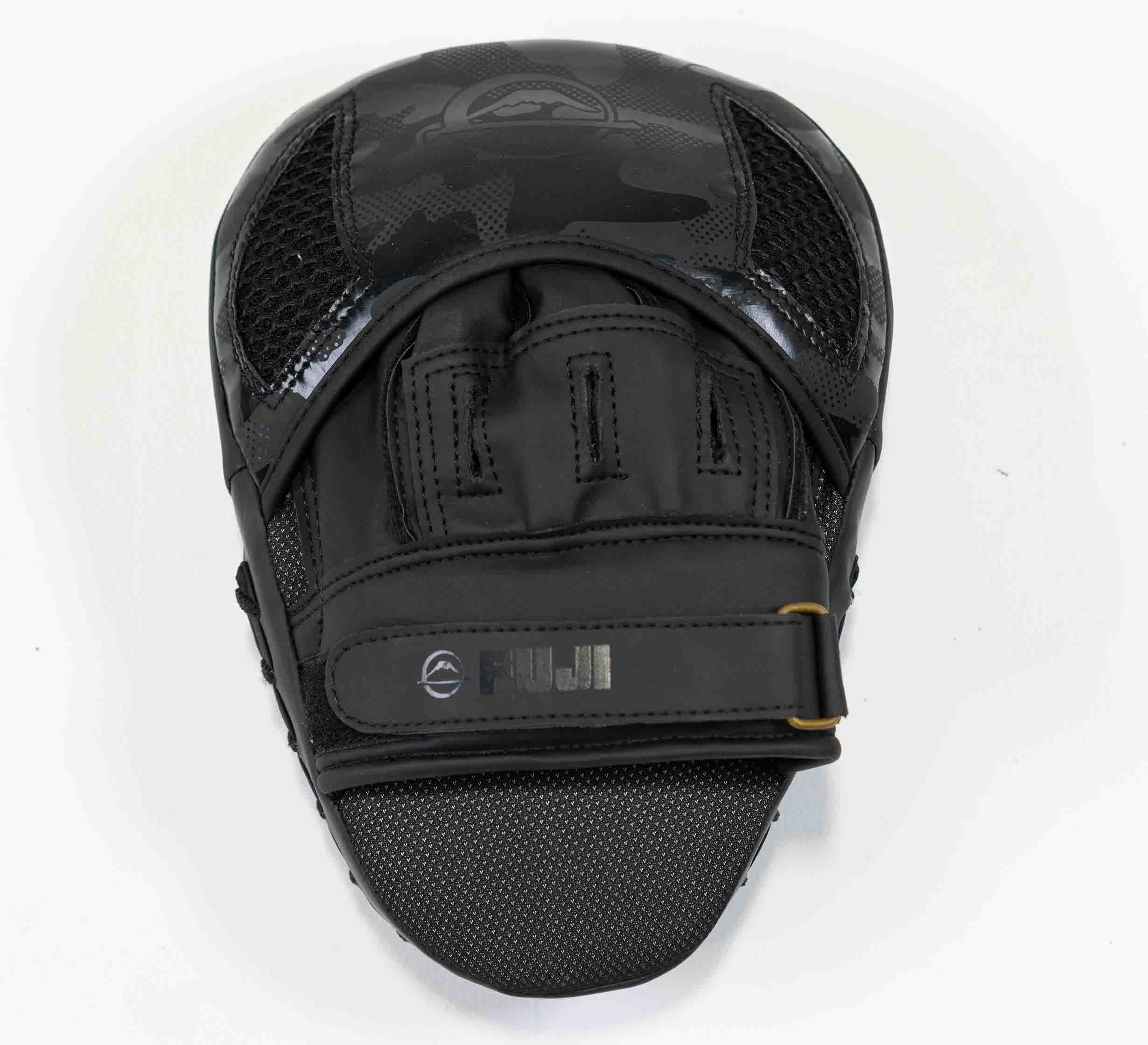 A black Raijin Focus Mitt with mesh accents, a secure strap, and a textured striking surface is shown from above on a white background.