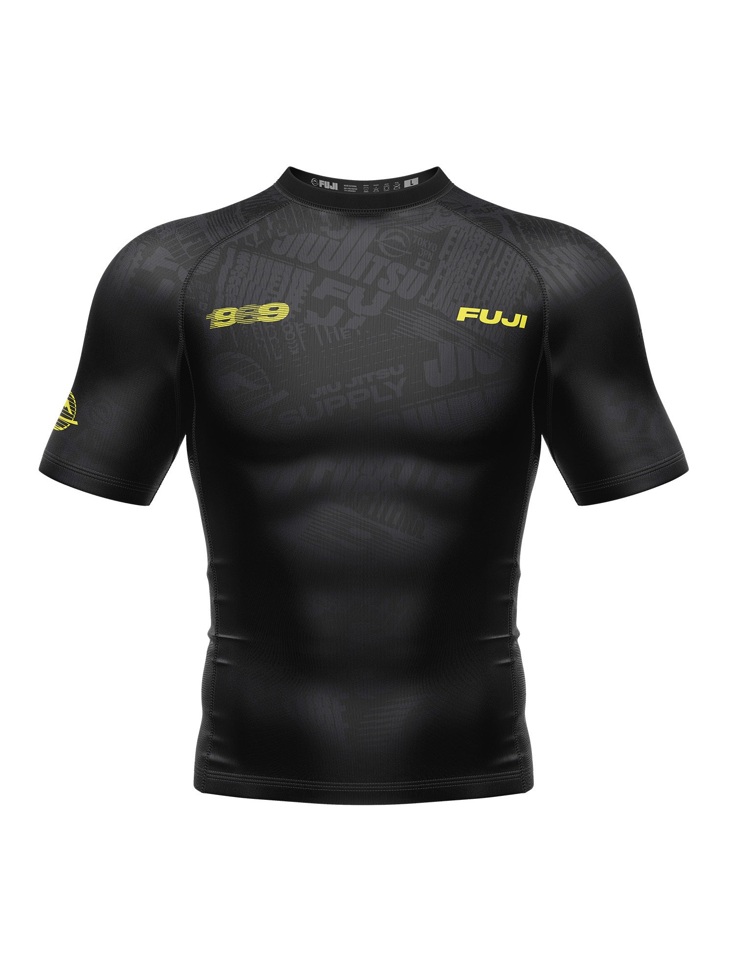 The Jiu jitsu Supply Flex Lite Rashguard Black is a fitted, high-performance short-sleeve compression shirt featuring subtle patterns, yellow "1989" and "FUJI" text on the chest, and a yellow logo on the left sleeve.