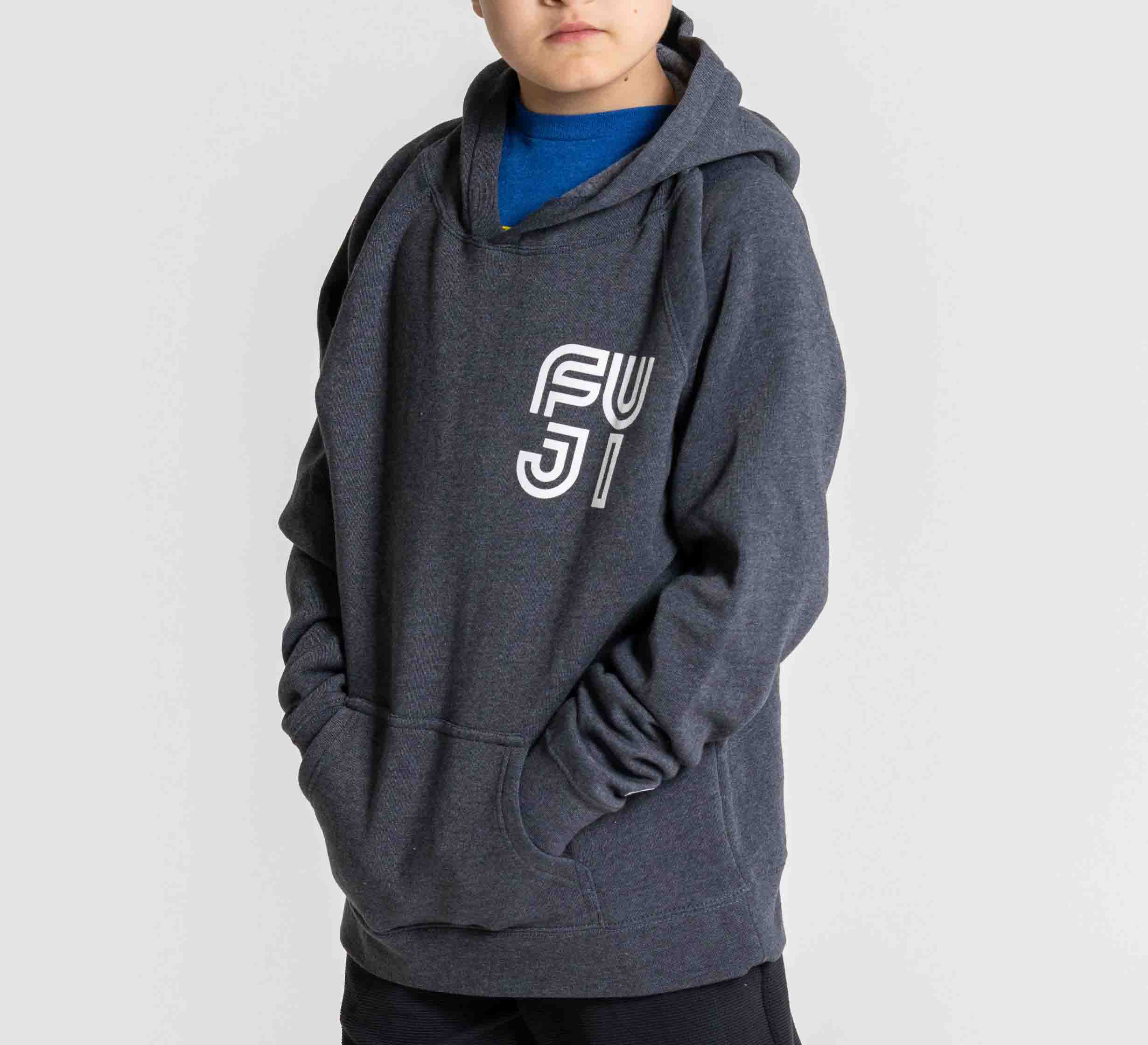 A child wears the Kids Jiu Jitsu Rally Hoodie in navy, featuring FUJI printed in white on the front, hands in the pocket, standing against a plain light background.