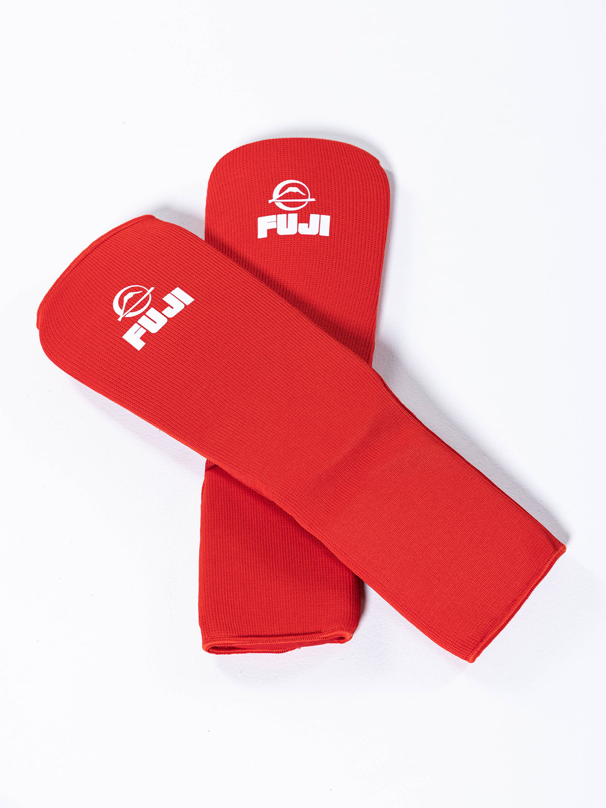 Two red FIAS Sambo Combat Shin Guards with a white logo printed near the top, displayed on a white background.