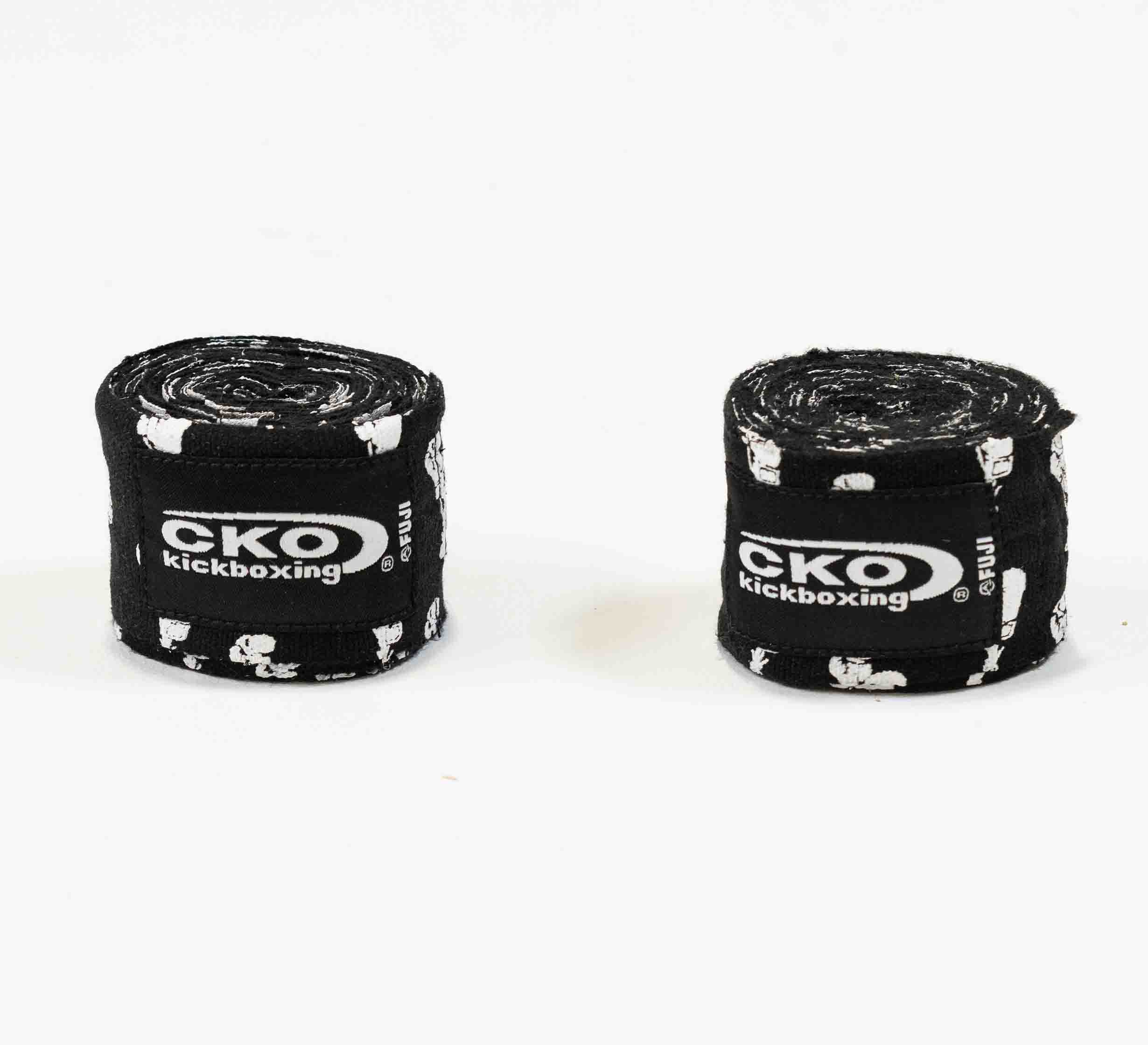 Two rolled-up CKO Hand Wraps With Boxing Gloves featuring black fabric, white patterns, and CKO Kickboxing logos are placed side by side on a plain white background.