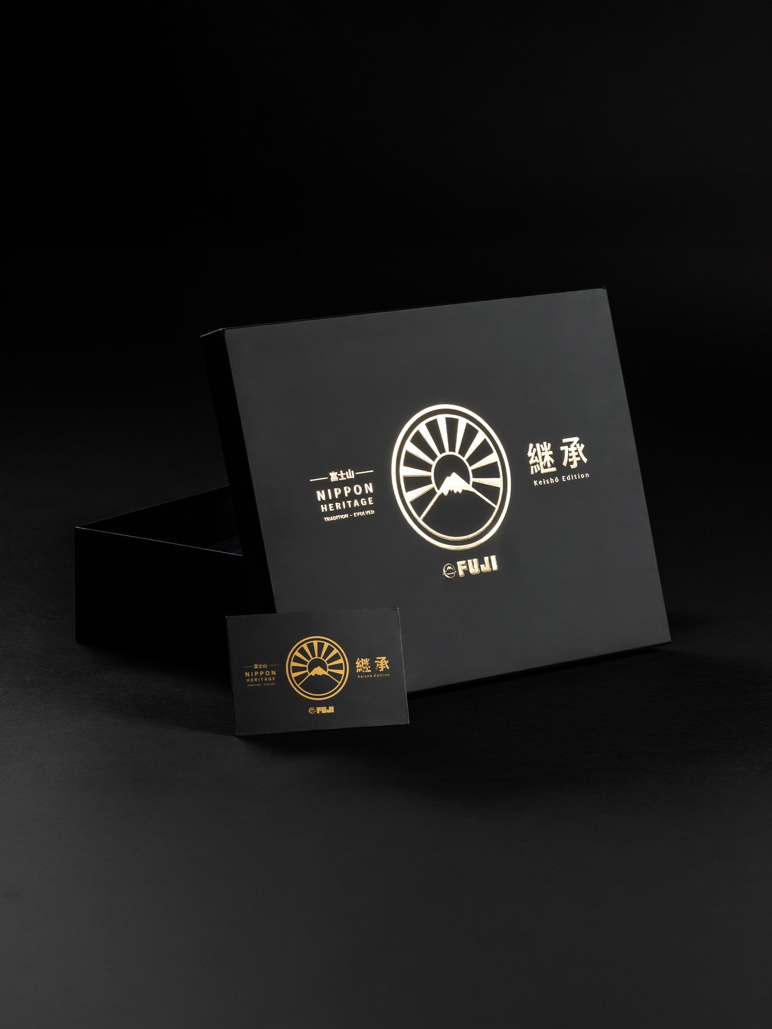 A black box featuring a gold Japanese-inspired logo and text, labeled Heritage Keishō Edition Bundle, is displayed with a matching smaller card on a black background.