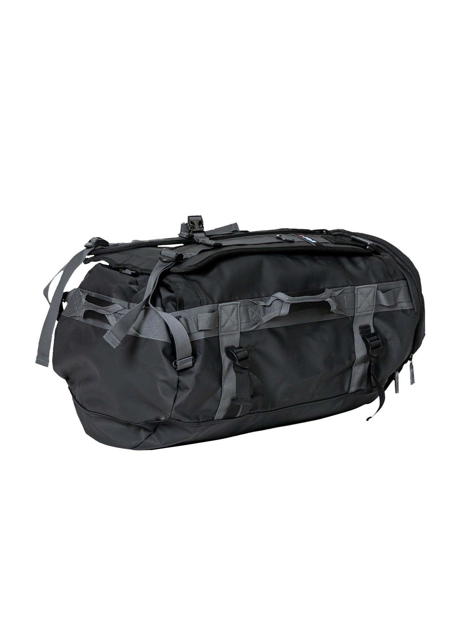 The Comp Duffle Black Grey is a large black bag with multiple gray straps and handles, featuring a zippered main compartment and external pockets, shown against a white background.