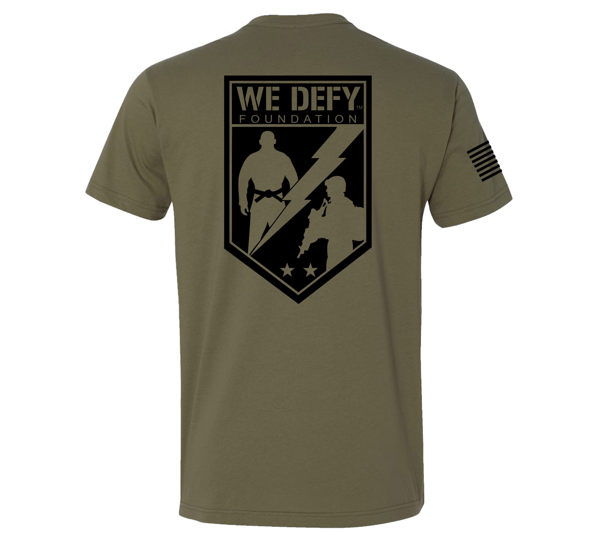 The We Defy Base T-Shirt Military Green features a large black WE DEFY FOUNDATION logo with two silhouettes, a lightning bolt, and three stars on the back, plus an American flag graphic on the right sleeve.
