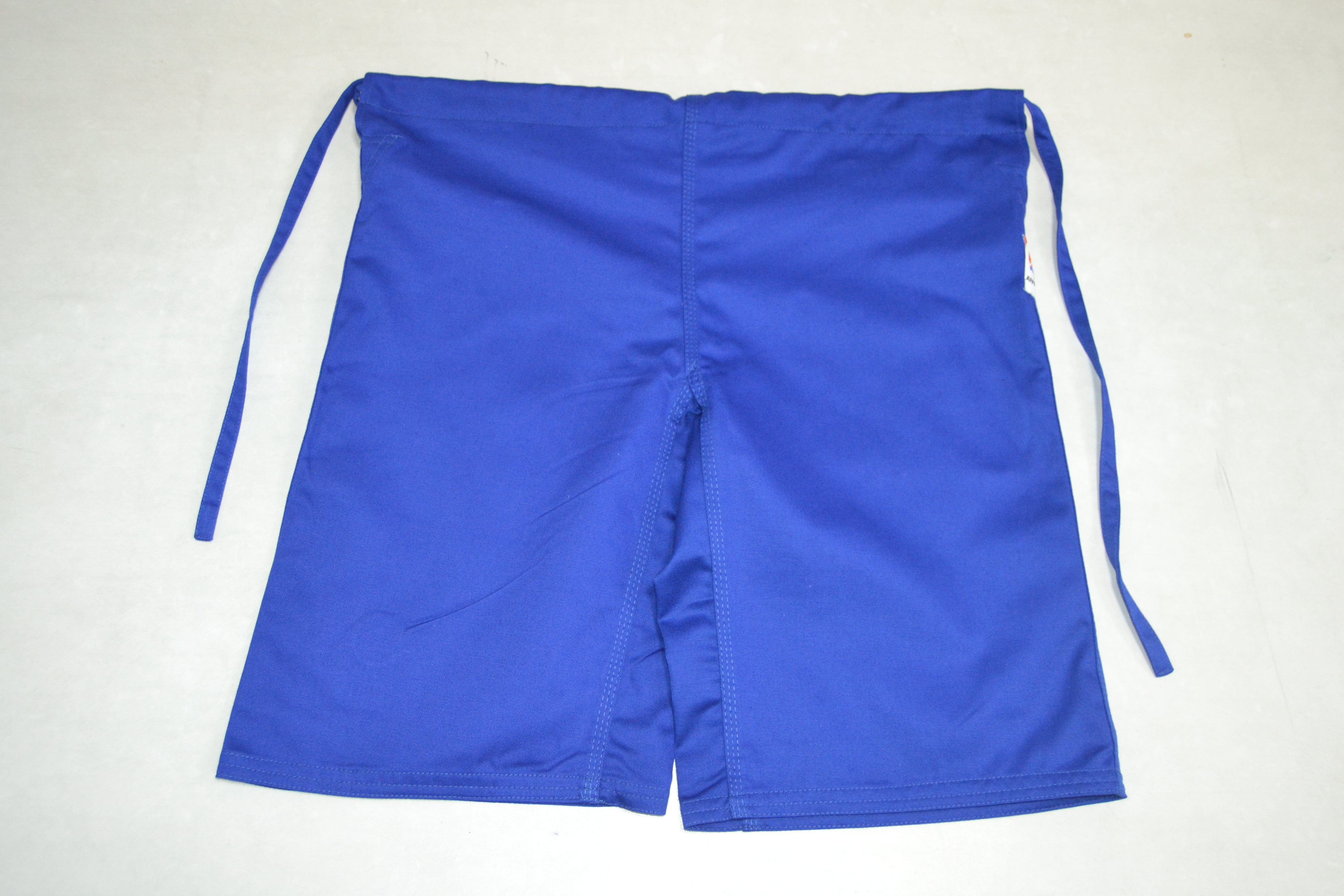 FIAS Combat Sambo Shorts Blue, featuring visible stitching and a small label on the right side, laid flat on a white surface with side tie strings.