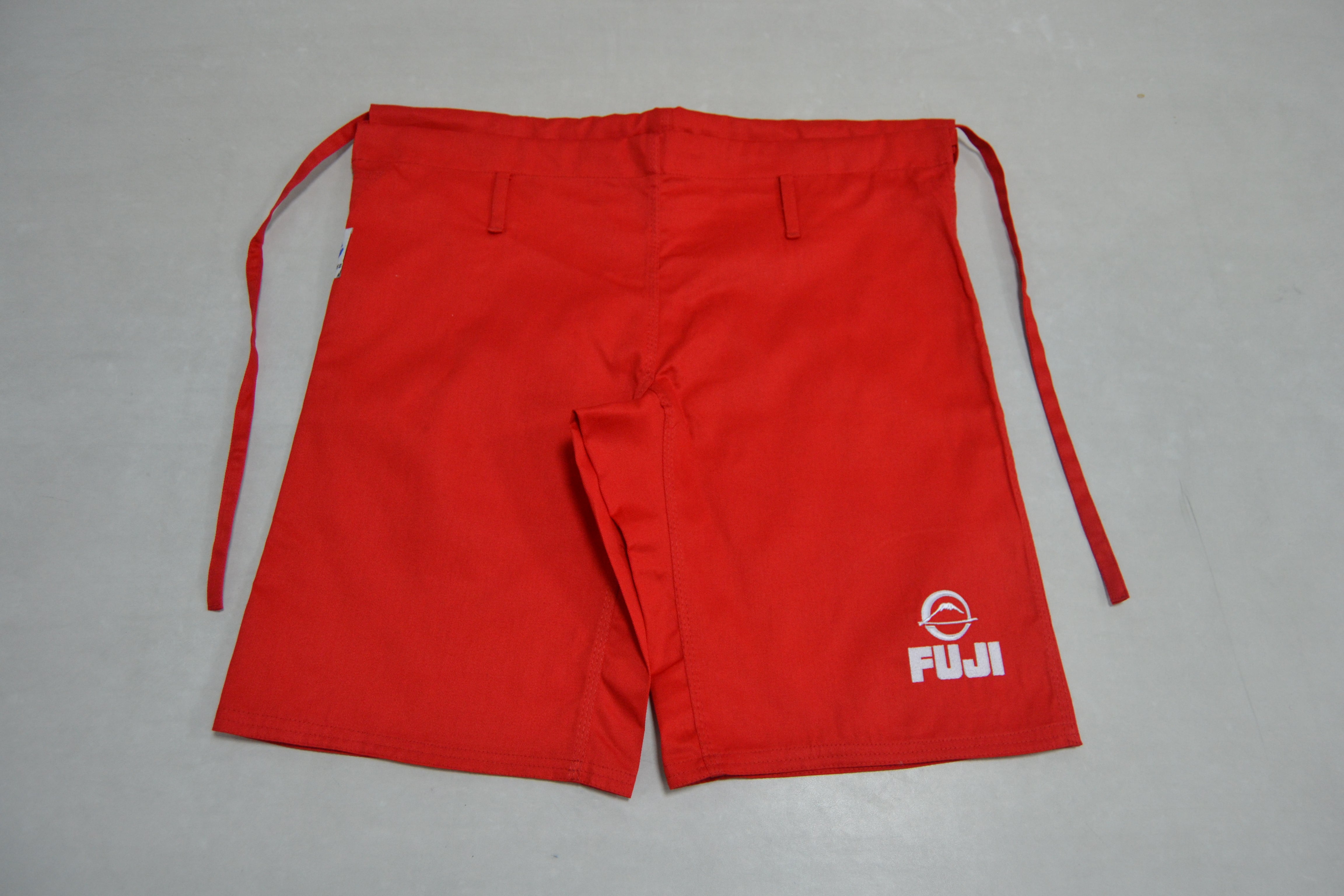 FIAS Combat Sambo Shorts Red with side ties, featuring a white Fuji logo and symbol on the lower left leg, are displayed flat on a light gray surface.