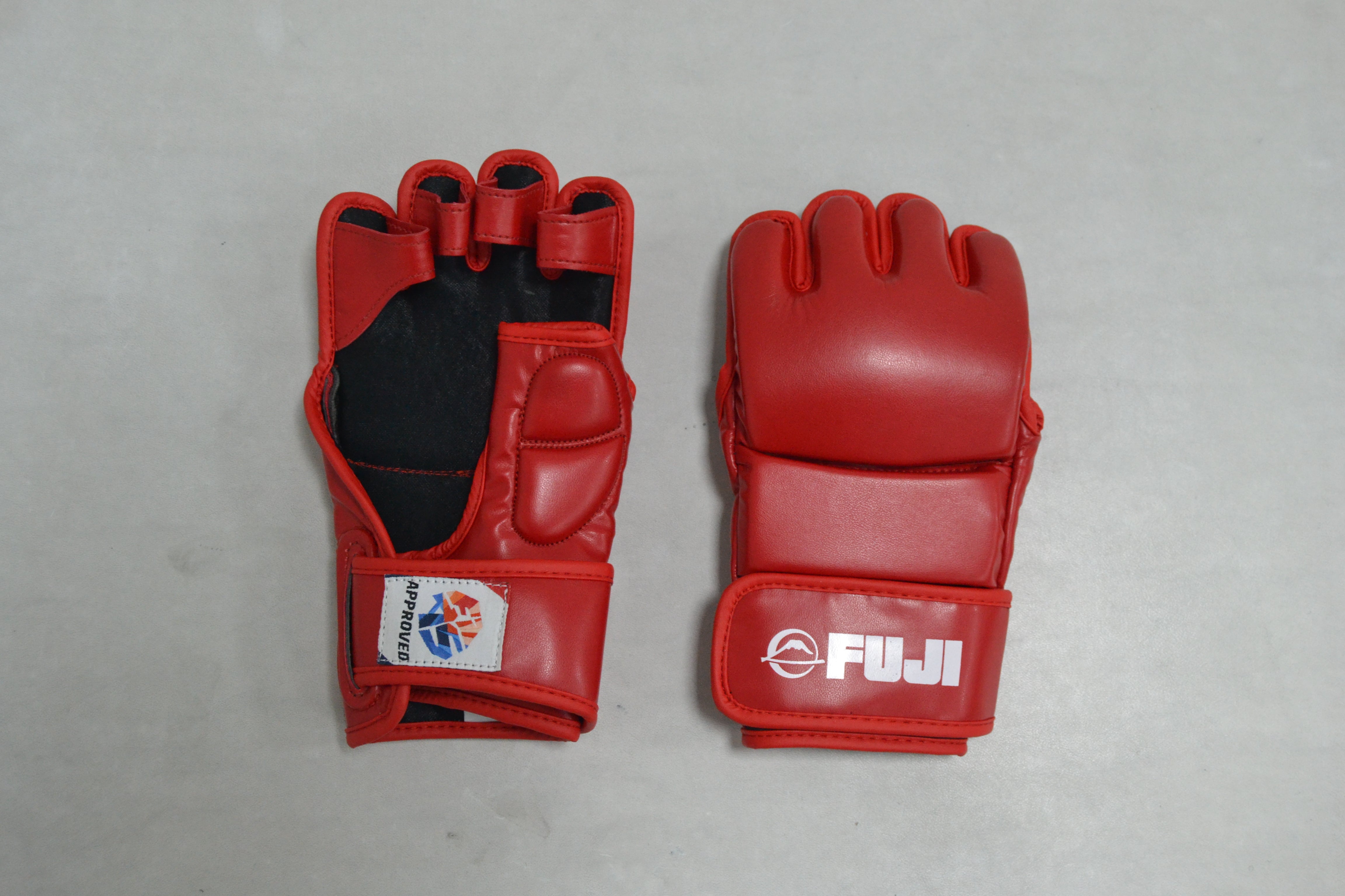 Two FIAS Sambo Combat Gloves Red are shown on a light surface. One glove displays the palm side, while the other shows the back with “FUJI” and a logo printed in white.