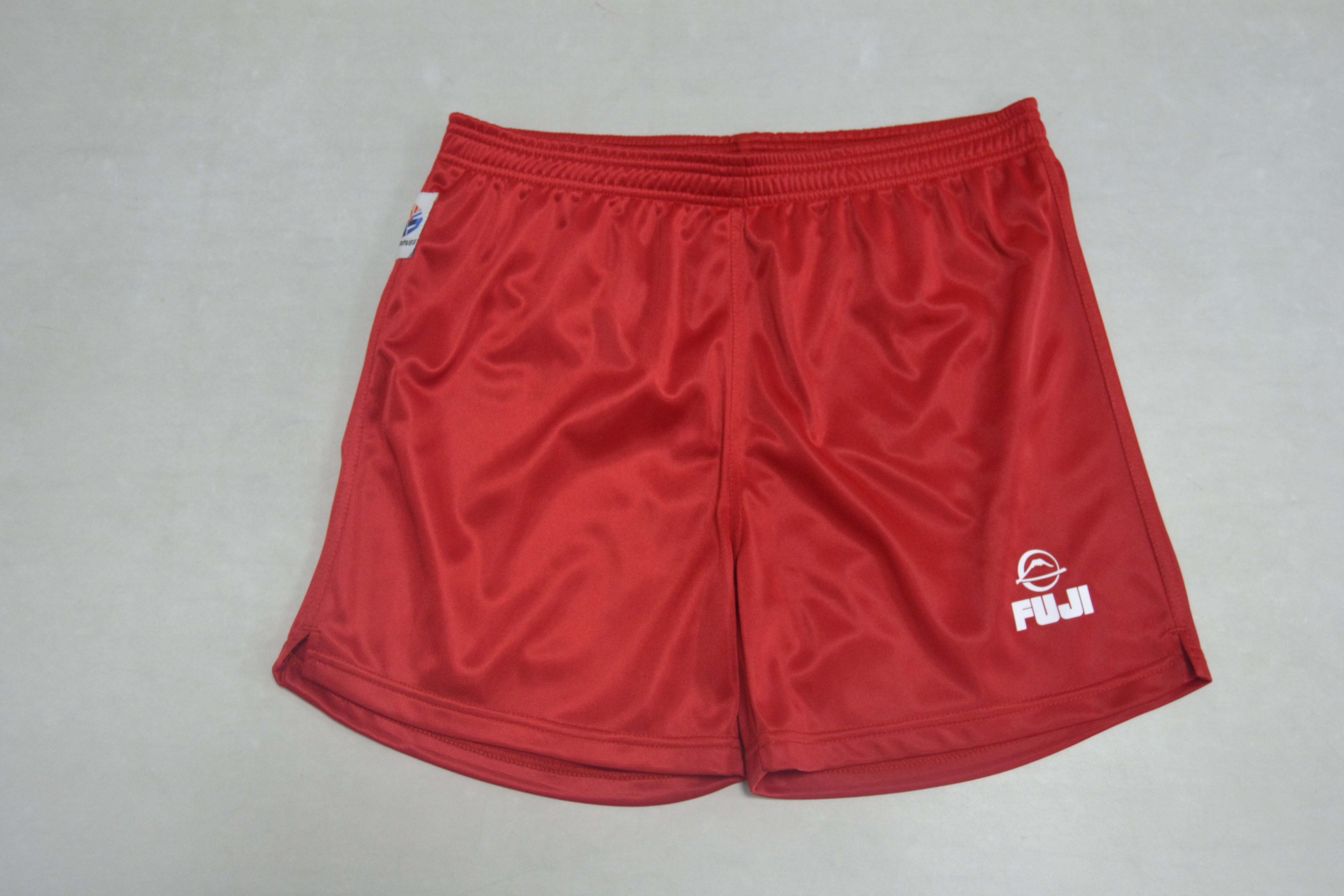 FIAS Sambo Shorts Red with an elastic waistband are laid flat on a light surface. The shorts feature a small FUJI logo and a white emblem on the front leg.