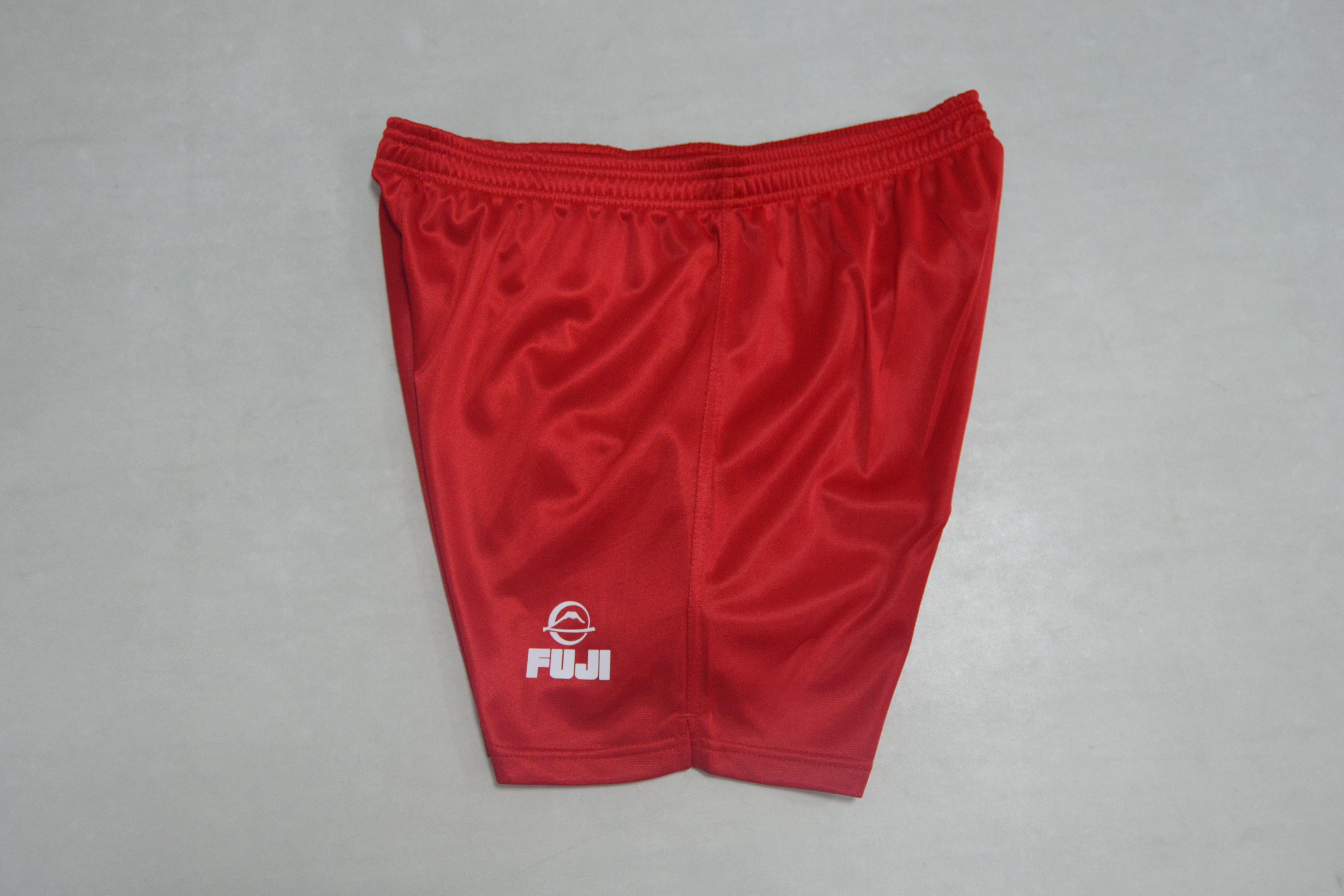 FIAS Sambo Shorts Red are bright red athletic shorts with an elastic waistband, featuring a small white Fuji logo and text near the bottom hem, displayed on a light gray background.