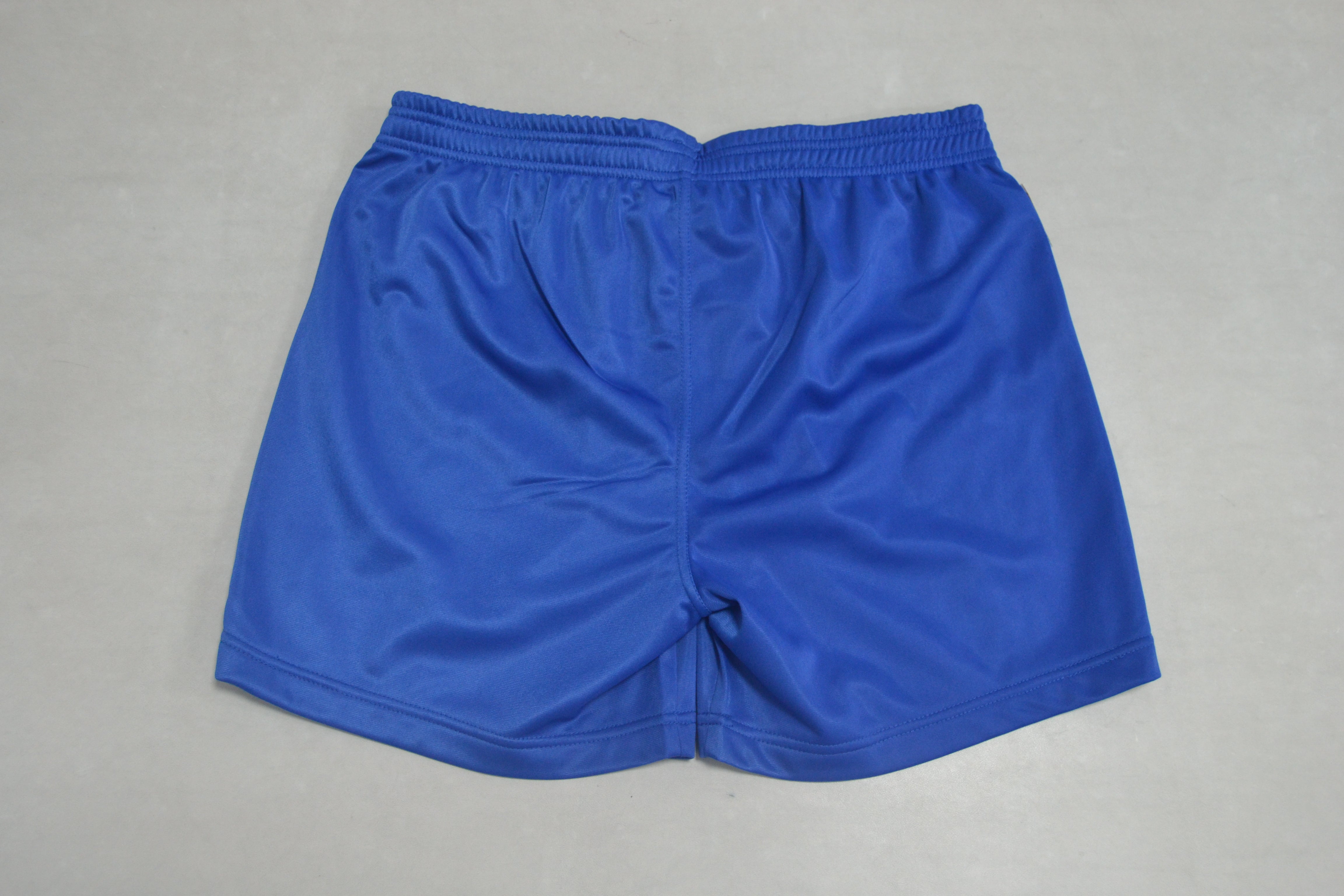 A pair of FIAS Sambo Shorts Blue with an elastic waistband, laid flat on a light gray surface.