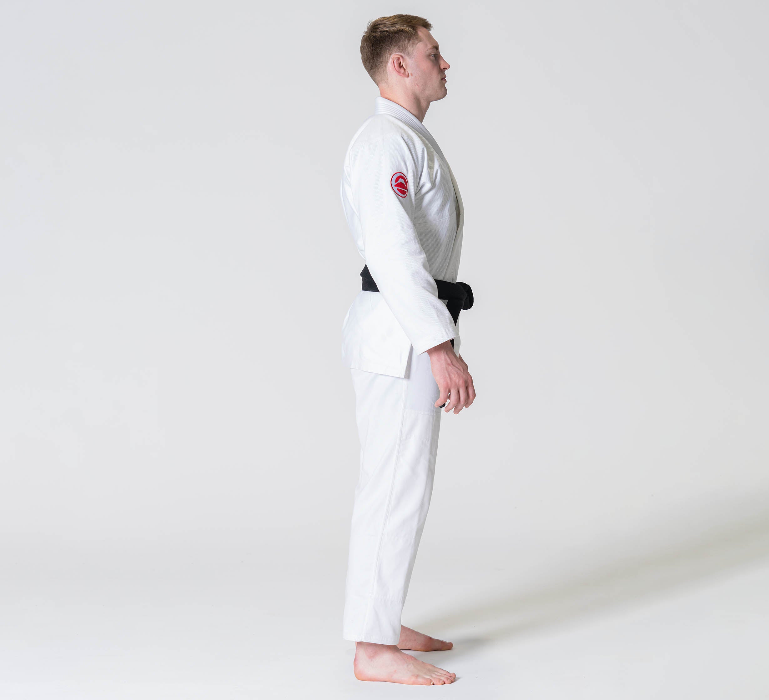 A man is wearing the Competition BJJ Gi White.