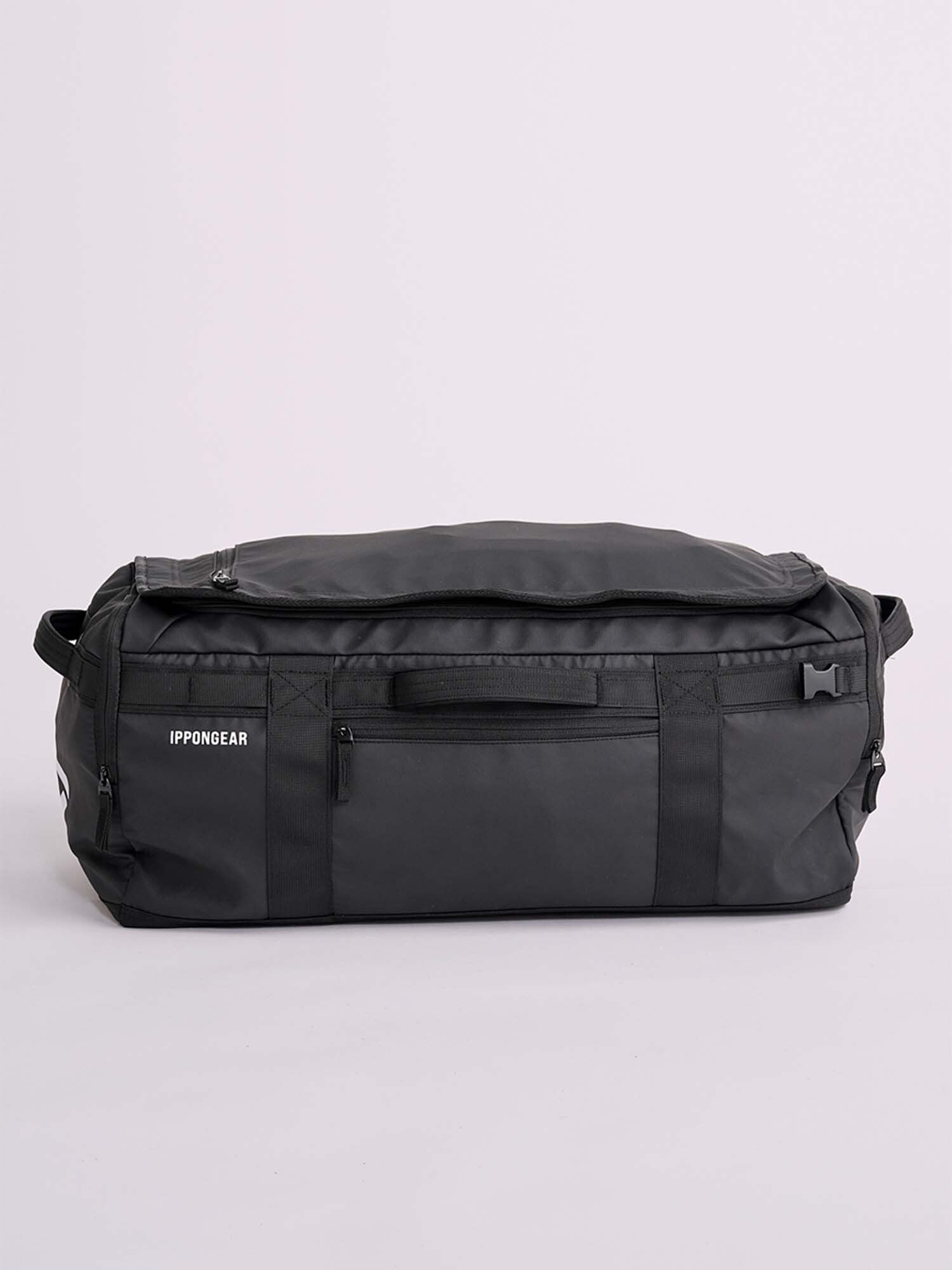 The IPPONGEAR 2 in 1 Sports Bag Black, a spacious duffel with zippered compartments and handles, is shown against a plain light background. The Ippon Gear logo appears on the side.