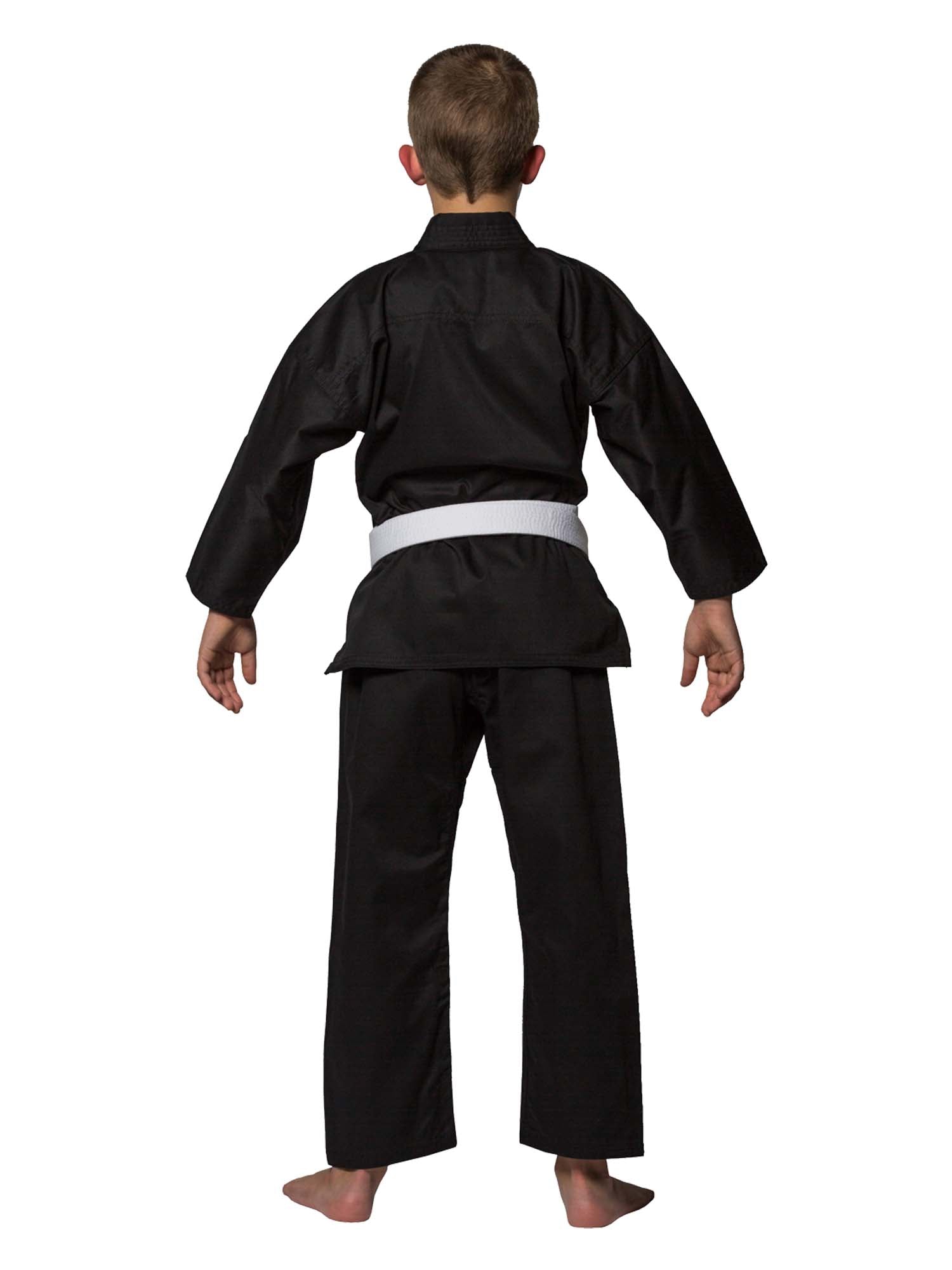 A young boy stands barefoot, facing away, wearing the Lightweight Karate Gi Black with a white belt against a plain white background.
