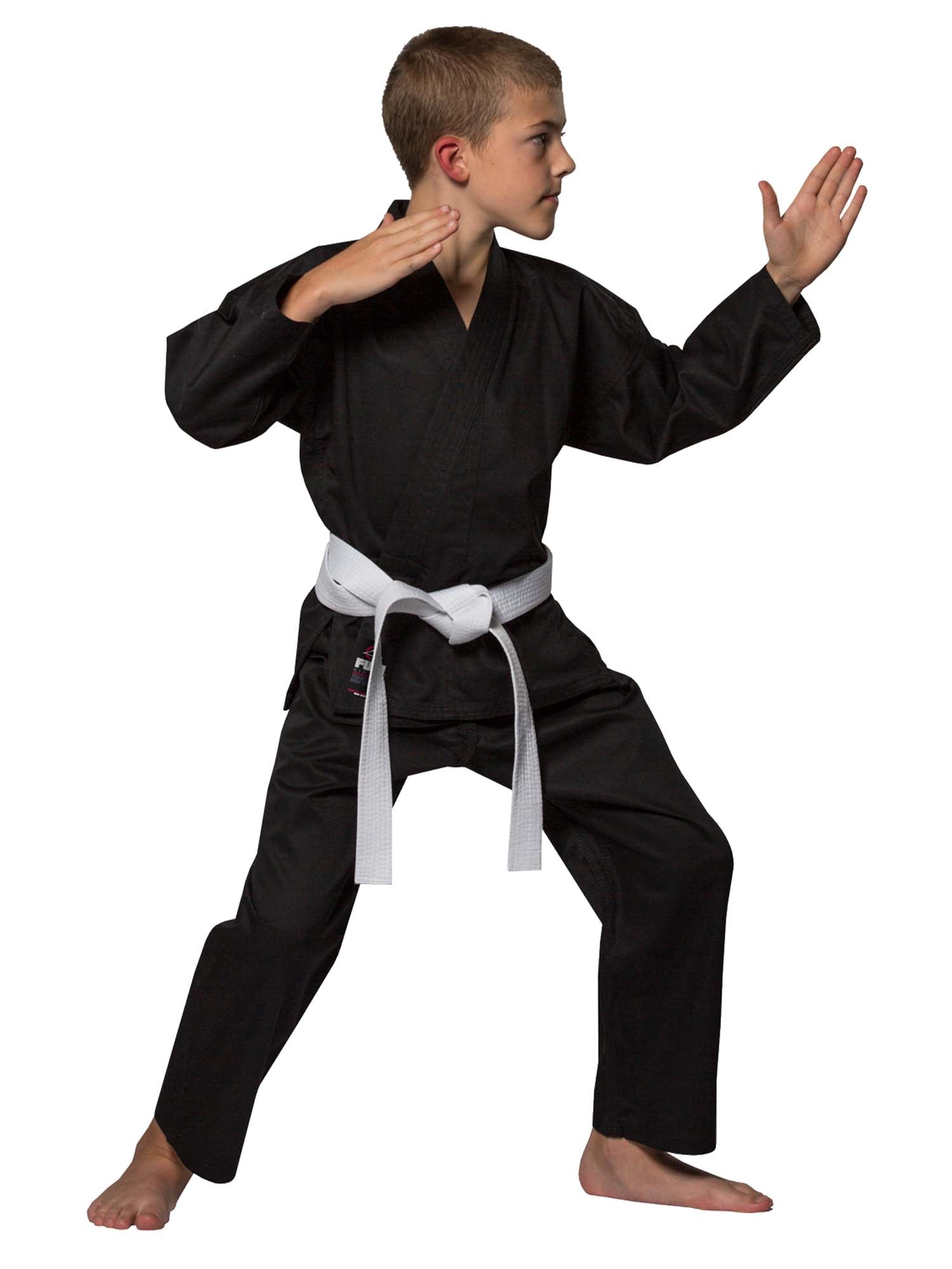 A boy in a Lightweight Karate Gi Black and white belt stands barefoot in a defensive stance with both arms raised, looking to the side.
