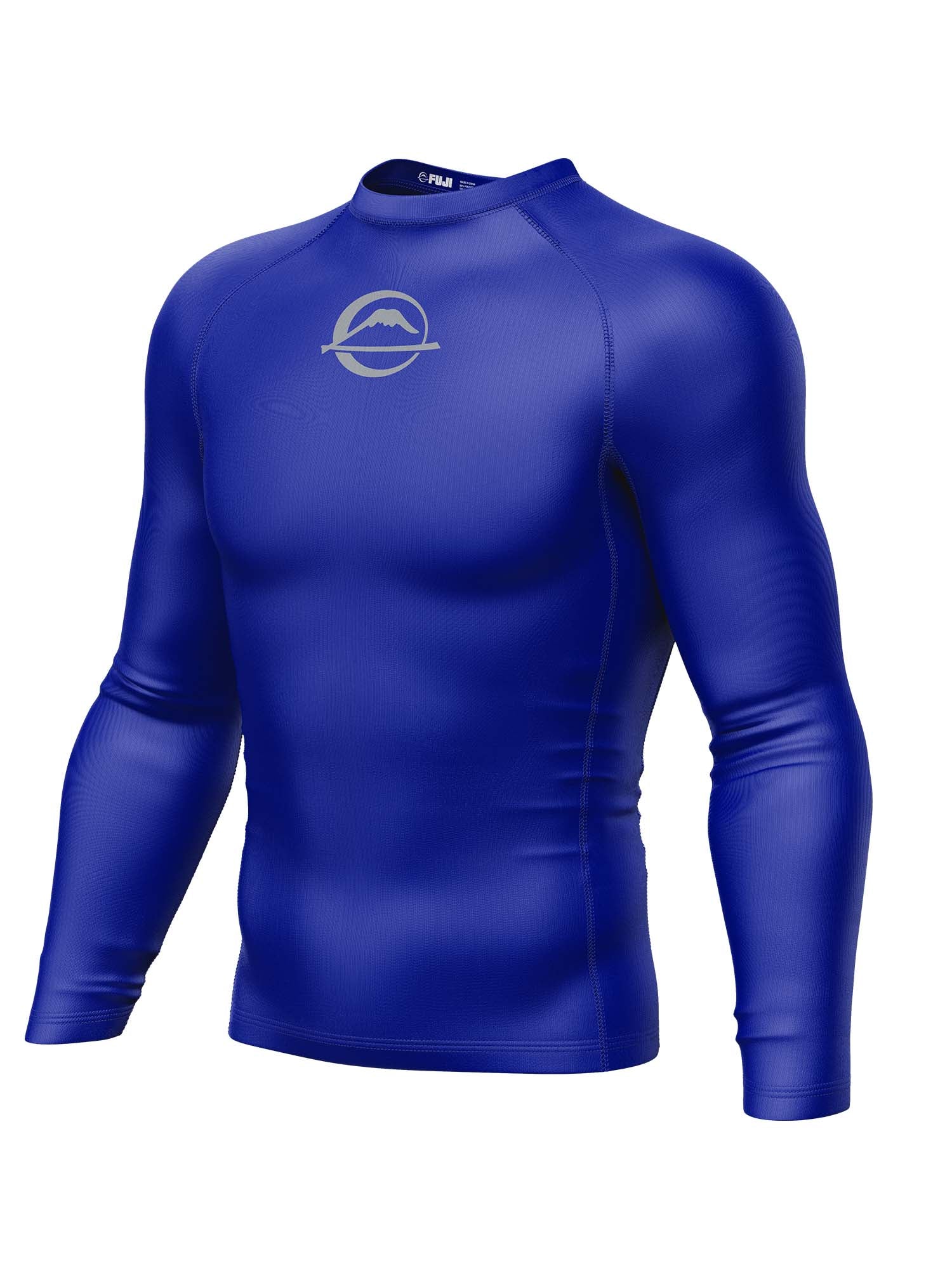 The Baseline Ranked Long Sleeve Rashguard Blue is a royal blue athletic compression shirt with long sleeves and a subtle mountain and ring logo on the chest, shown on a white background.