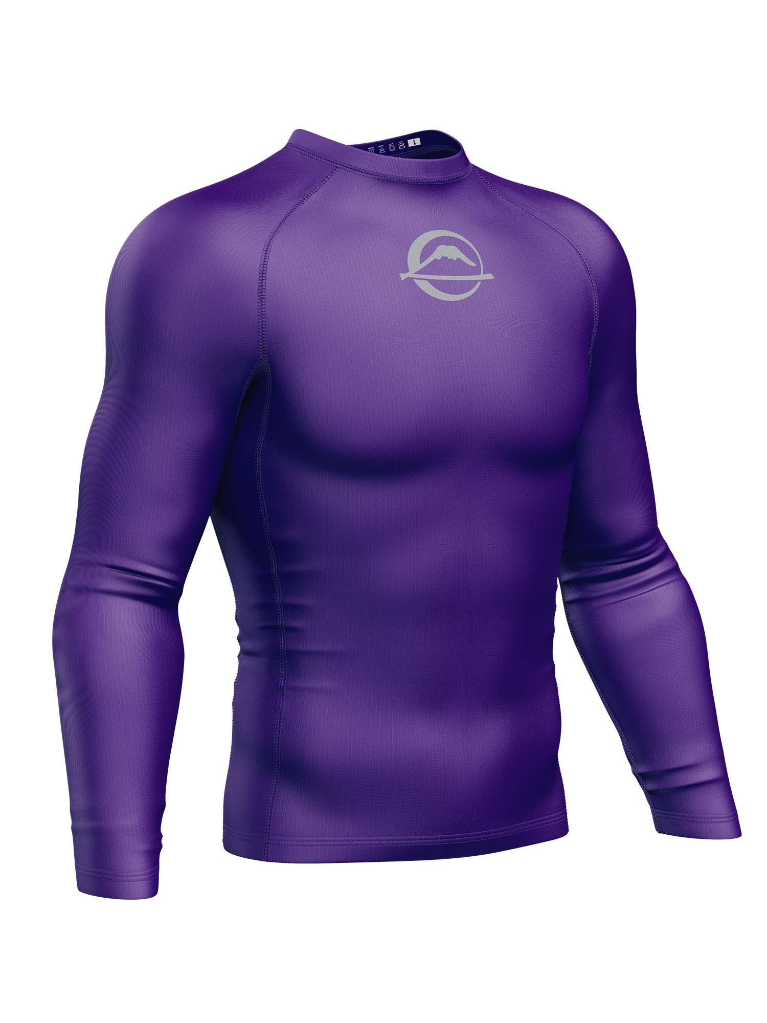 The Baseline Ranked Long Sleeve Rashguard Purple is a form-fitting athletic shirt featuring solid purple fabric and a small circular white logo on the upper chest, shown on a mannequin against a plain white background.