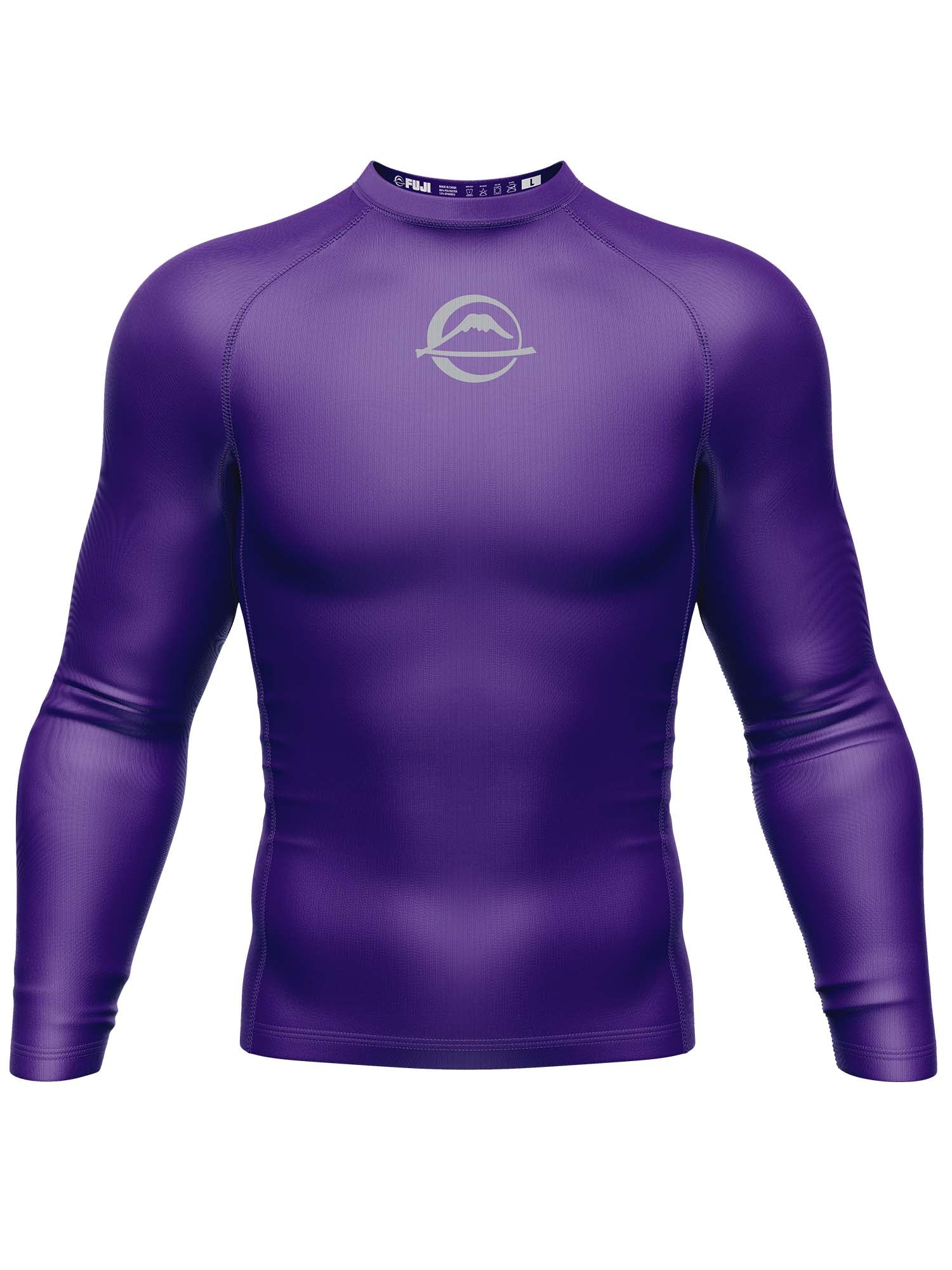 The Baseline Ranked Long Sleeve Rashguard Purple is a form-fitting athletic shirt featuring solid purple color and a small white chest logo, displayed on a plain white background.