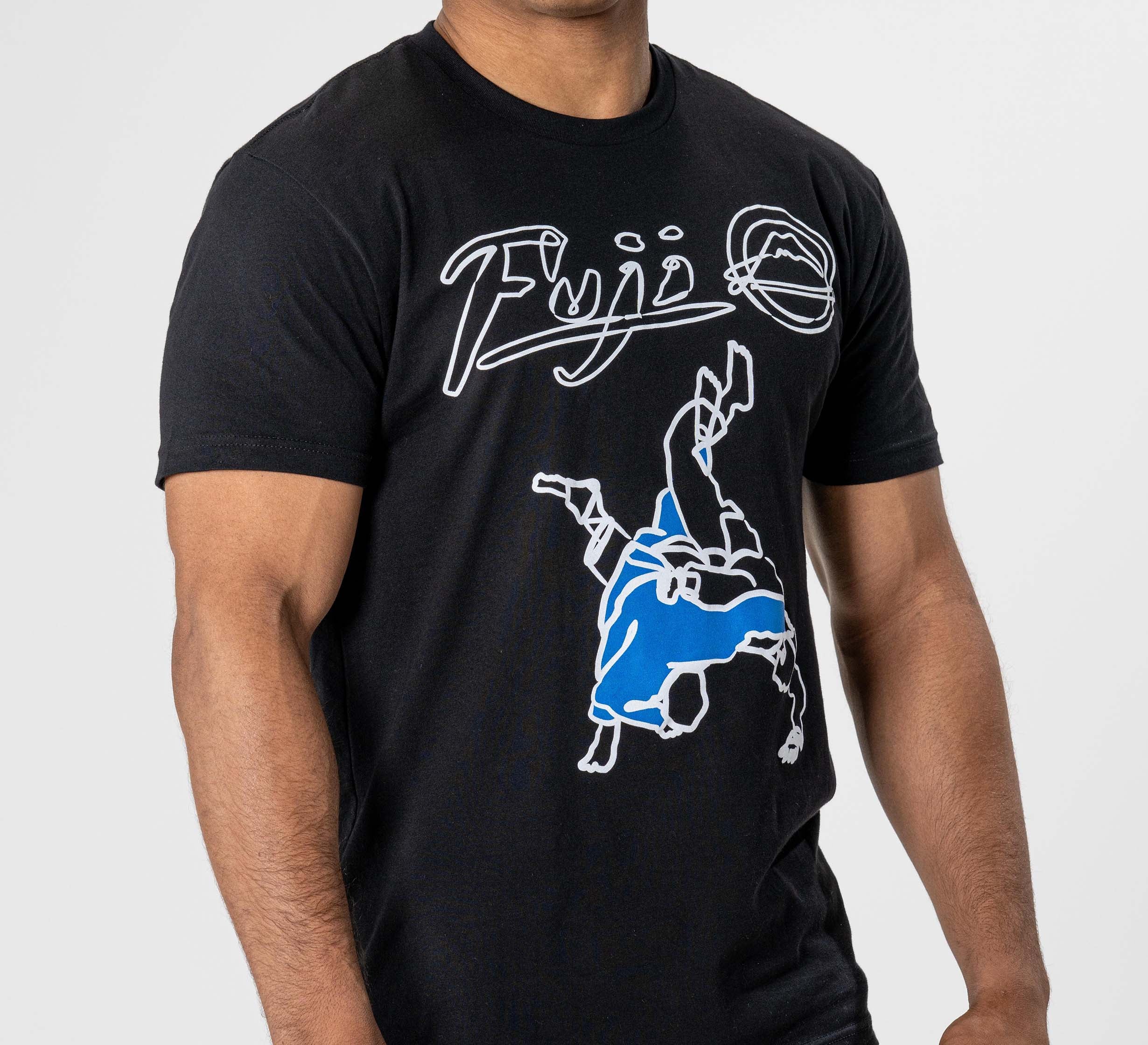 Someone is wearing the FUJI Takedown T-Shirt Black, featuring "Fuji" in white and a blue-and-white graphic of two people grappling, symbolizing martial arts.