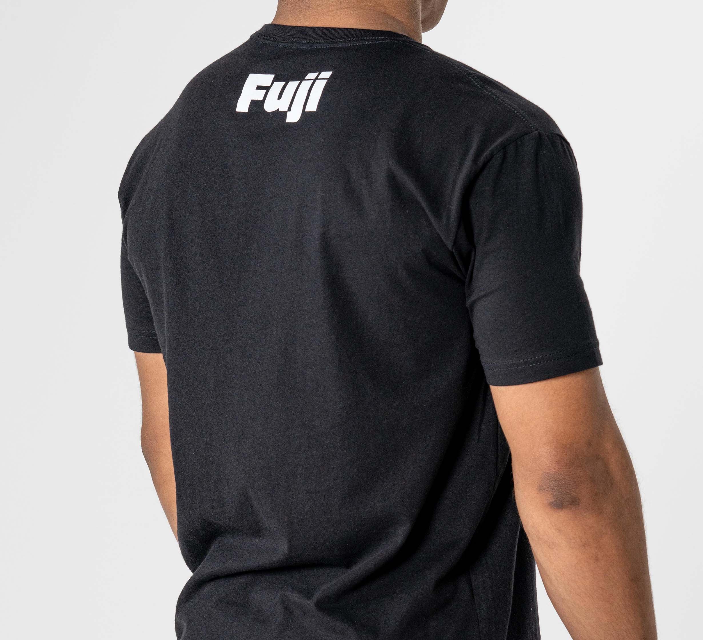 Someone is seen from behind wearing the Jiu Jitsu Player T-Shirt Black, featuring "Fuji" in white text on the upper back, against a plain light background.