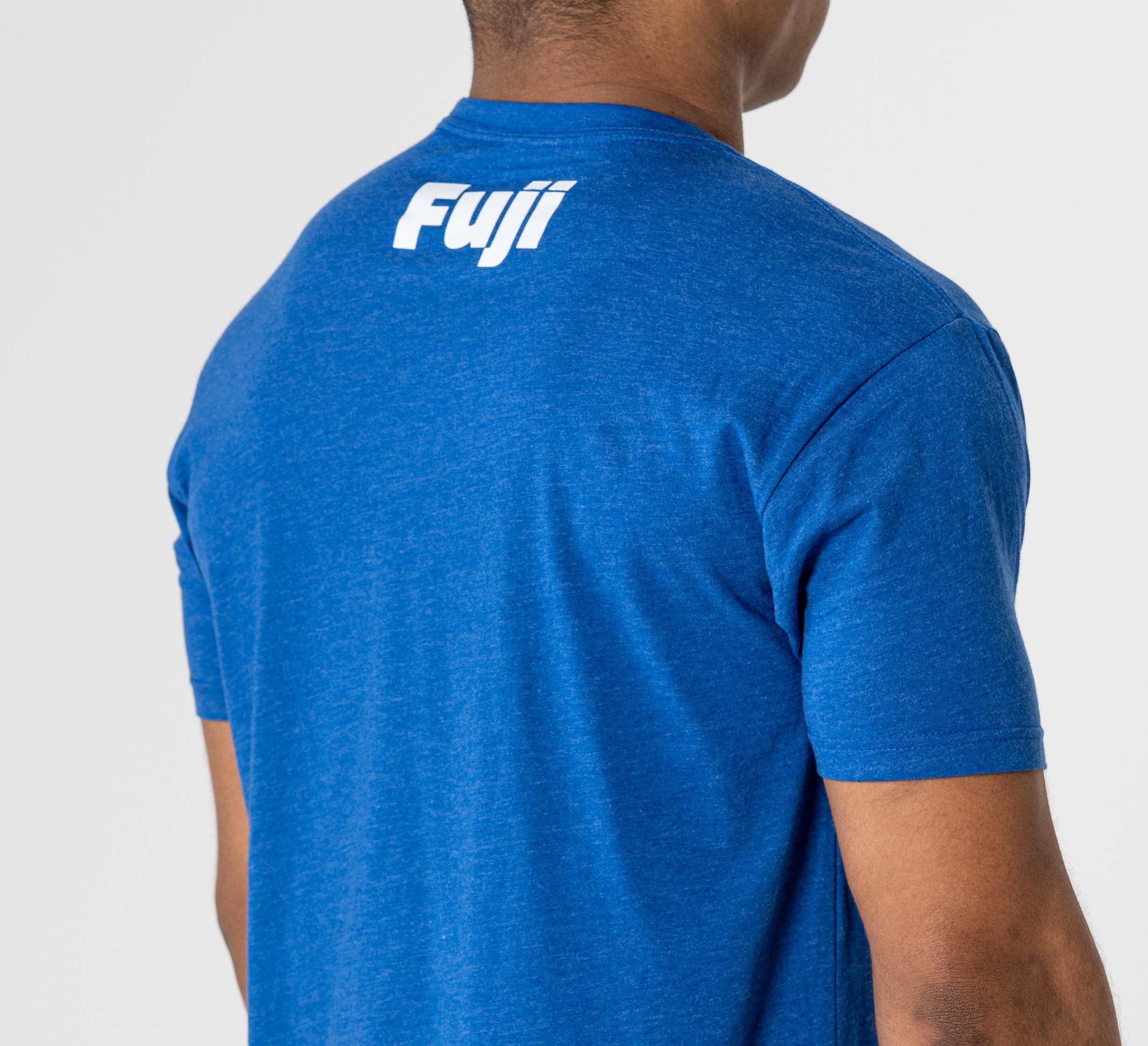 A person is seen from behind wearing the Jiu Jitsu Player T-Shirt Blue, featuring "Fuji" printed in white on the upper back.