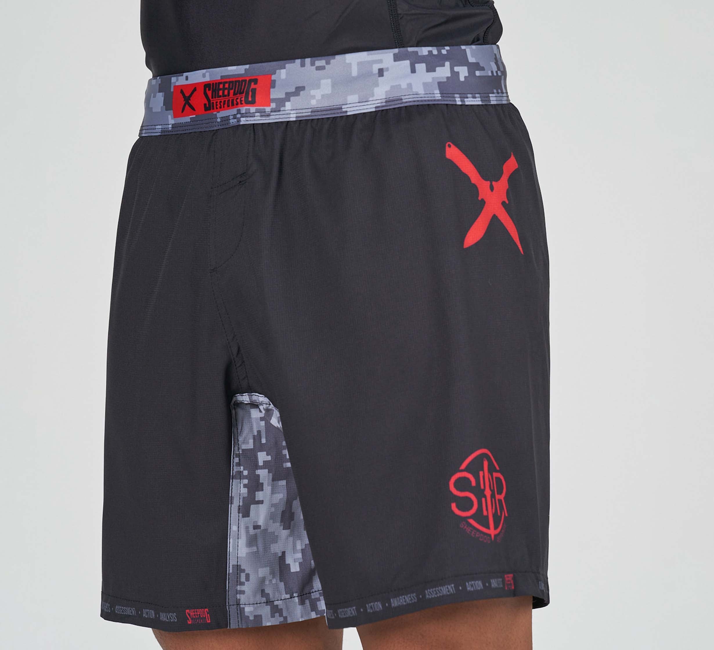 Person wearing Sheepdog Response Flex Lite Shorts Black, featuring a gray digital camo waistband and side panel with red crossed-out X and SHR insignia logos near the hem.