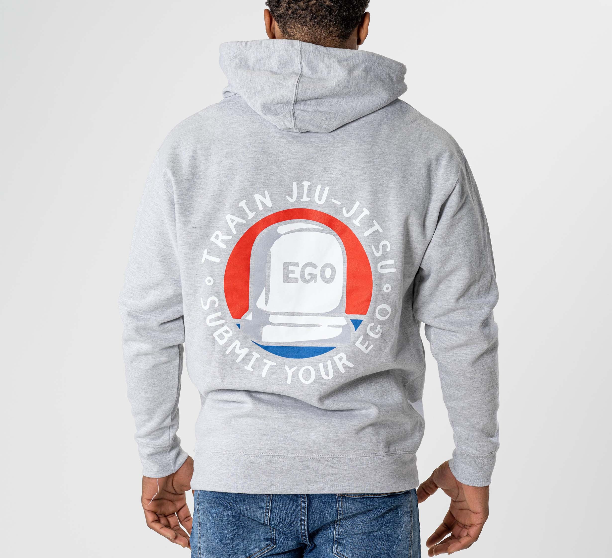 Wearing the Submit Your Ego Hoodie Heather Grey, which features a white chess piece labeled EGO and the words "TRAIN JIU-JITSU SUBMIT YOUR EGO" in a circular pattern on the back.