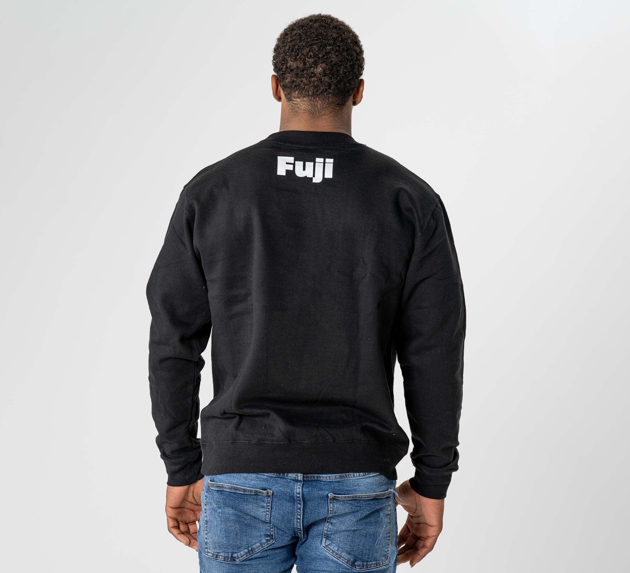 A person wearing the Jiu Jitsu Player Crewneck Black, featuring "Fuji" printed in white on the upper back, is shown from behind against a plain light background.