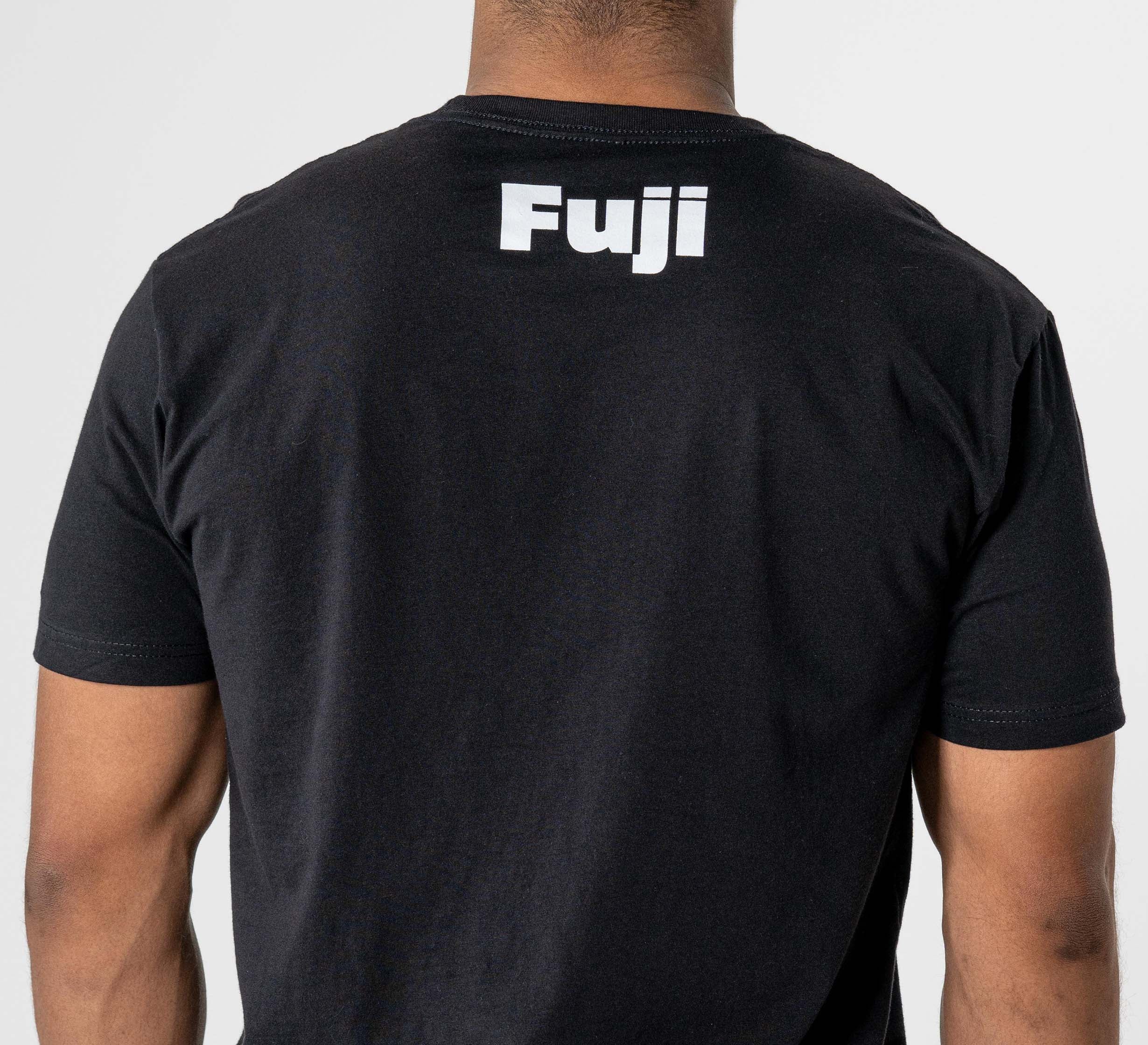 A person wearing the Jiu Jitsu Player T-Shirt Black, featuring "Fuji" in white lettering on the upper back, is photographed from behind against a plain light background.