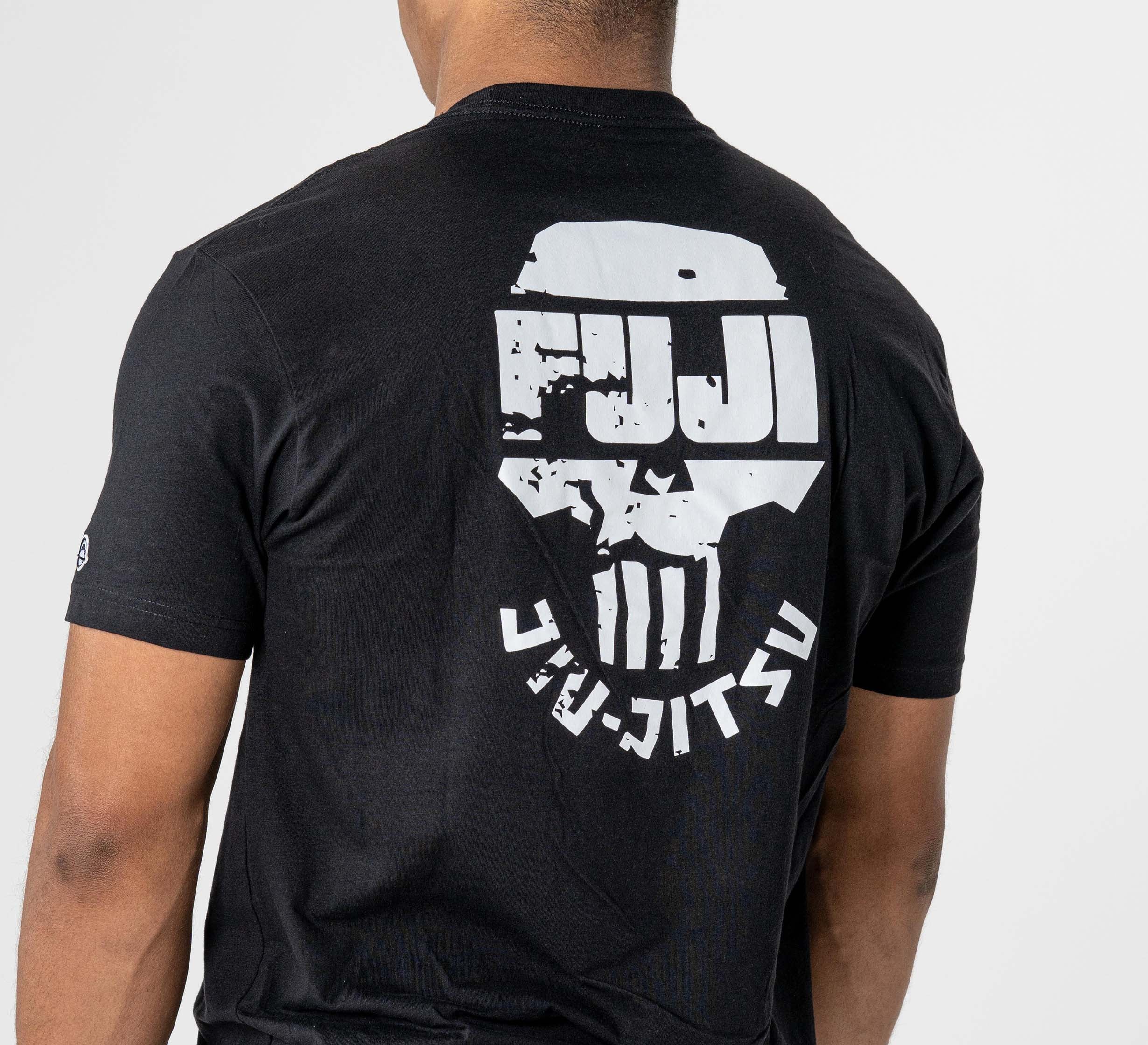 A person turned away from the camera wears the Punishment T-Shirt Black, which features a white “FUJI JIU JITSU” graphic and a stylized skull design on the back.