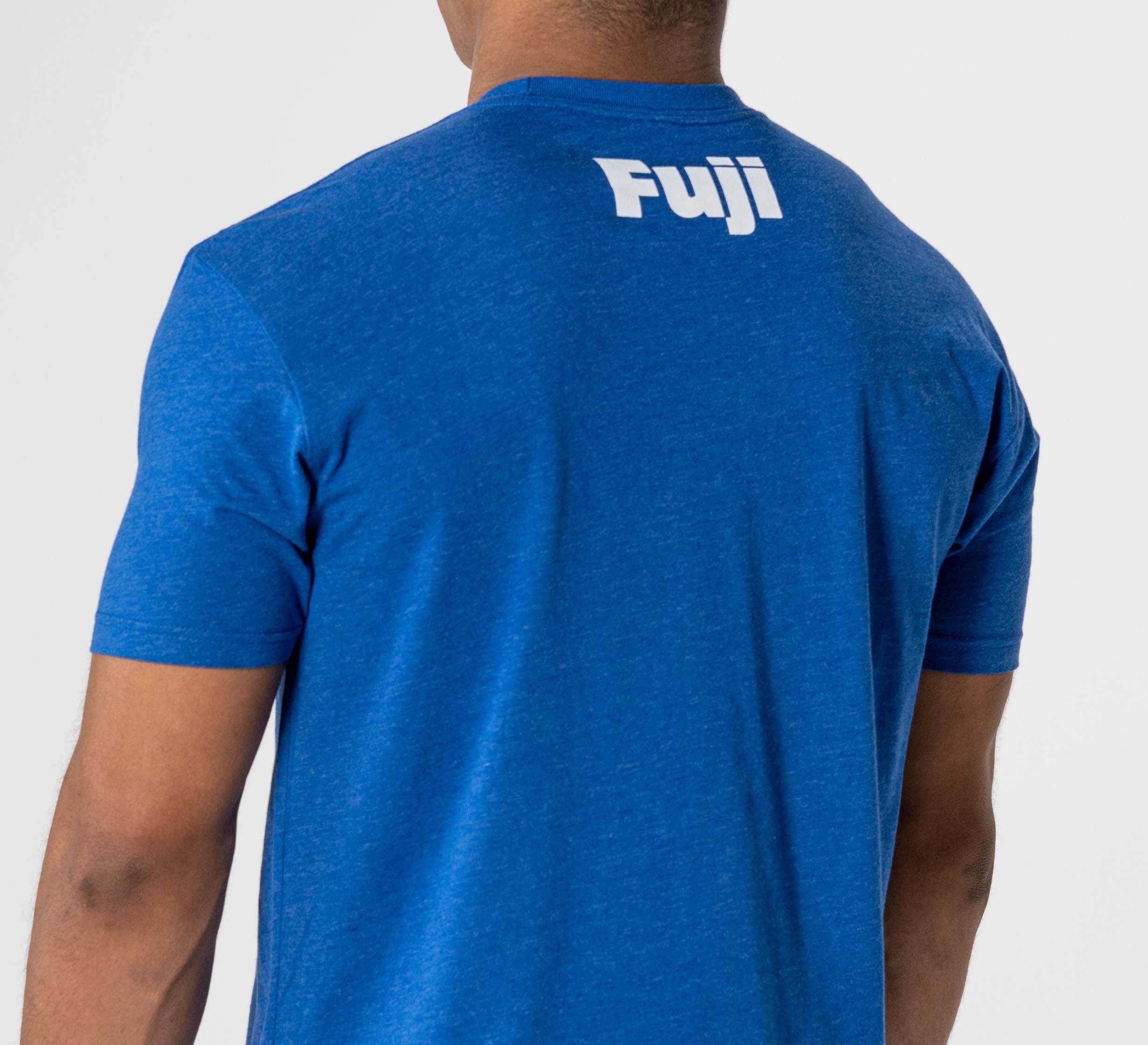 A person is seen from behind wearing the Jiu Jitsu Player T-Shirt Blue, featuring "Fuji" printed in white on the upper back, photographed against a plain white background.