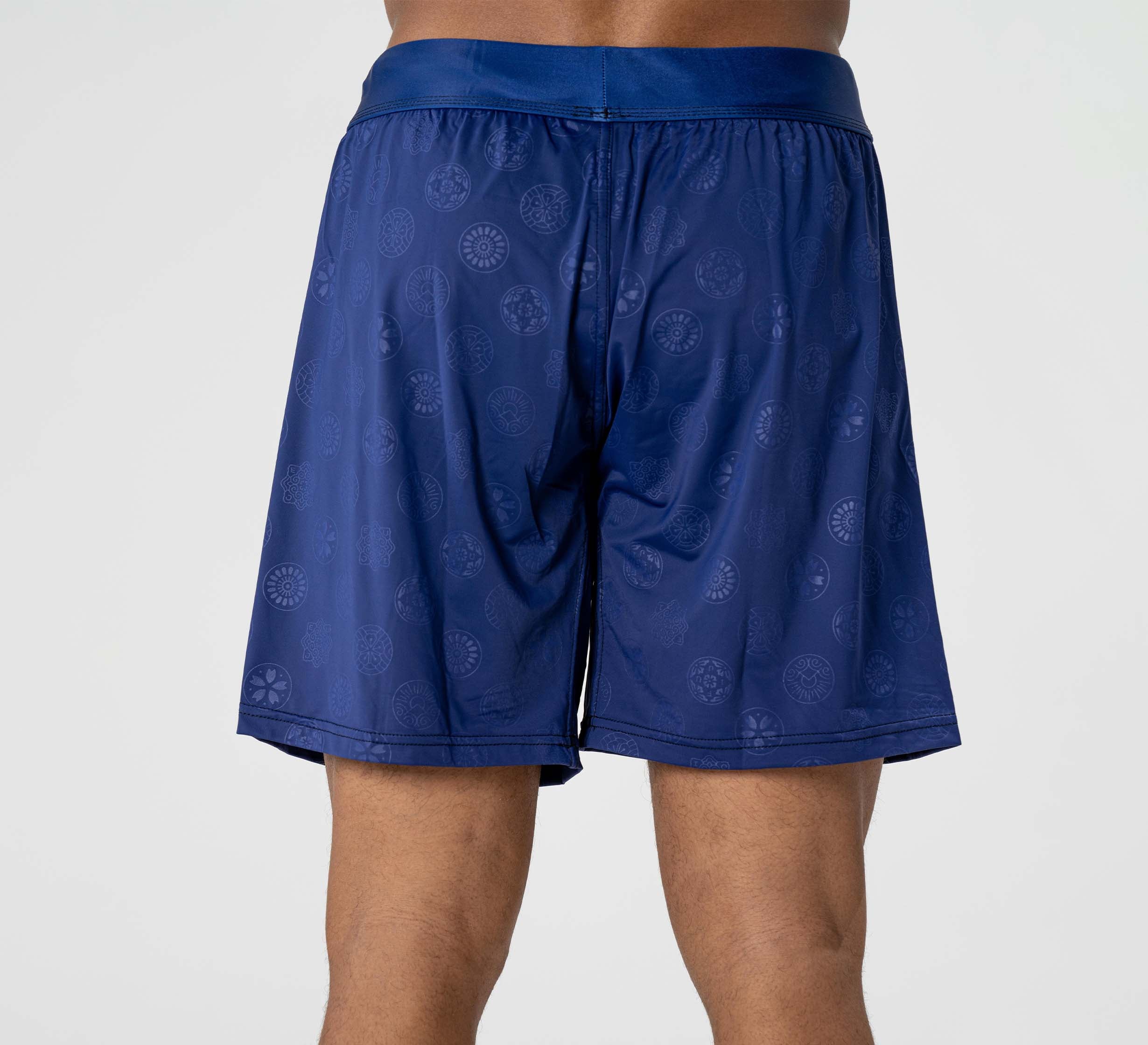 A person wearing Shogun Heat Gear Shorts Navy, shown from the back against a plain light background.