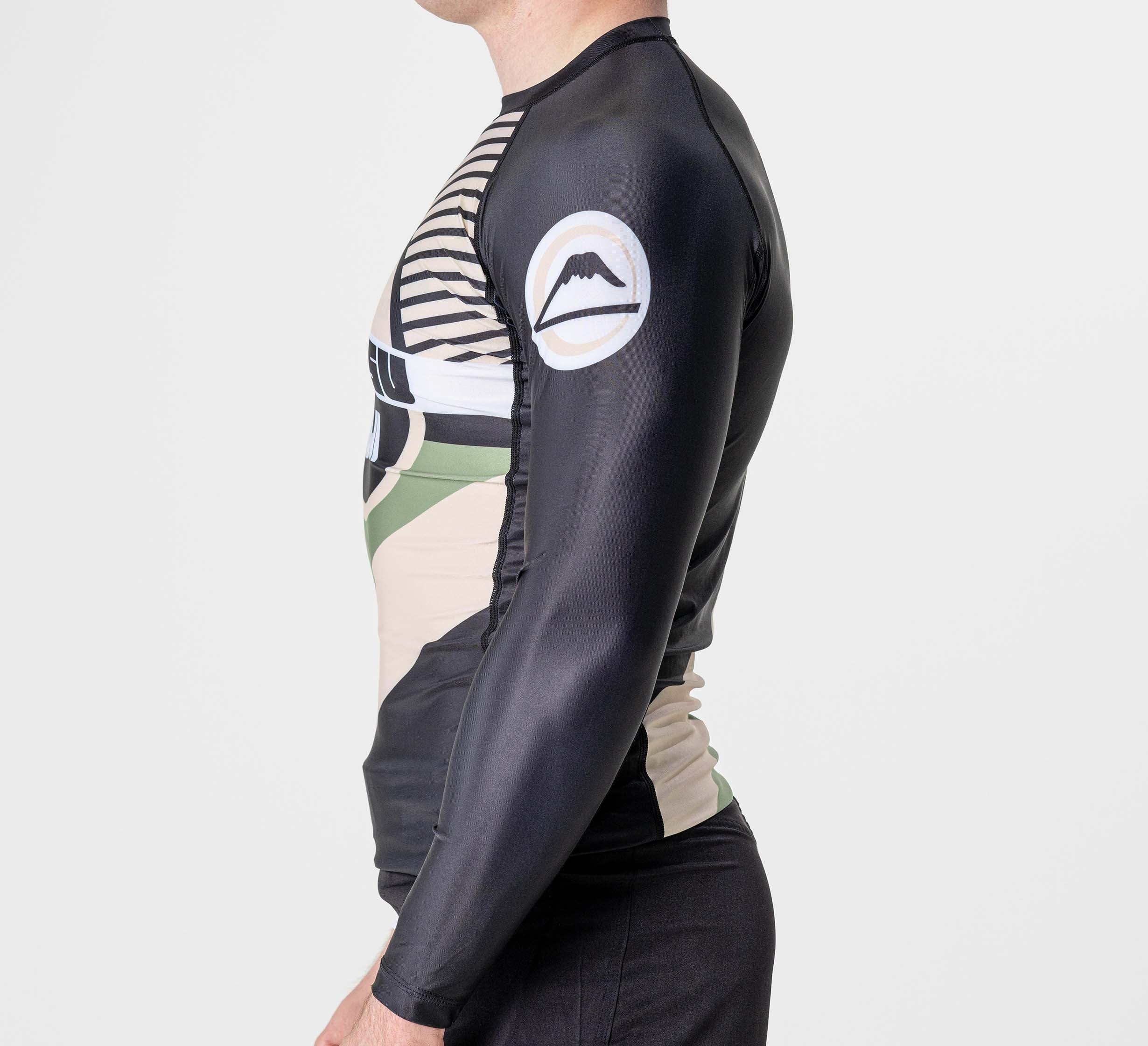 A man wearing the Pacer Flex Lite Long Sleeve Rashguard in black.