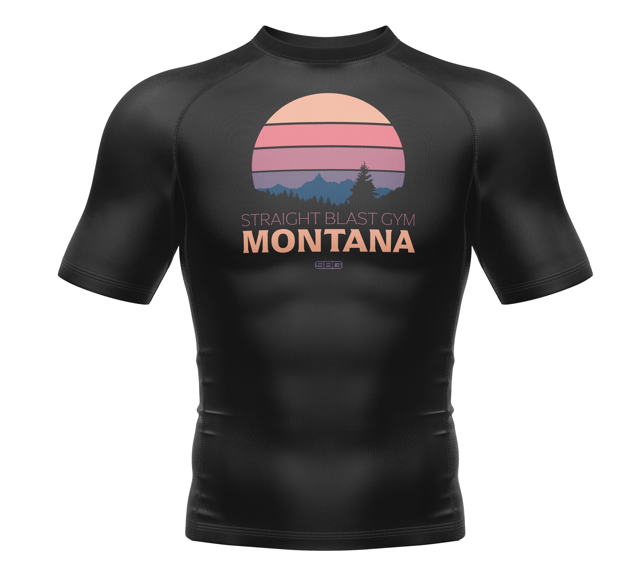 Kids SBG Montana Themed Rashguard: black short-sleeve athletic shirt with a pastel sunset, mountain, and tree graphic plus "Straight Blast Gym Montana" text on the front.