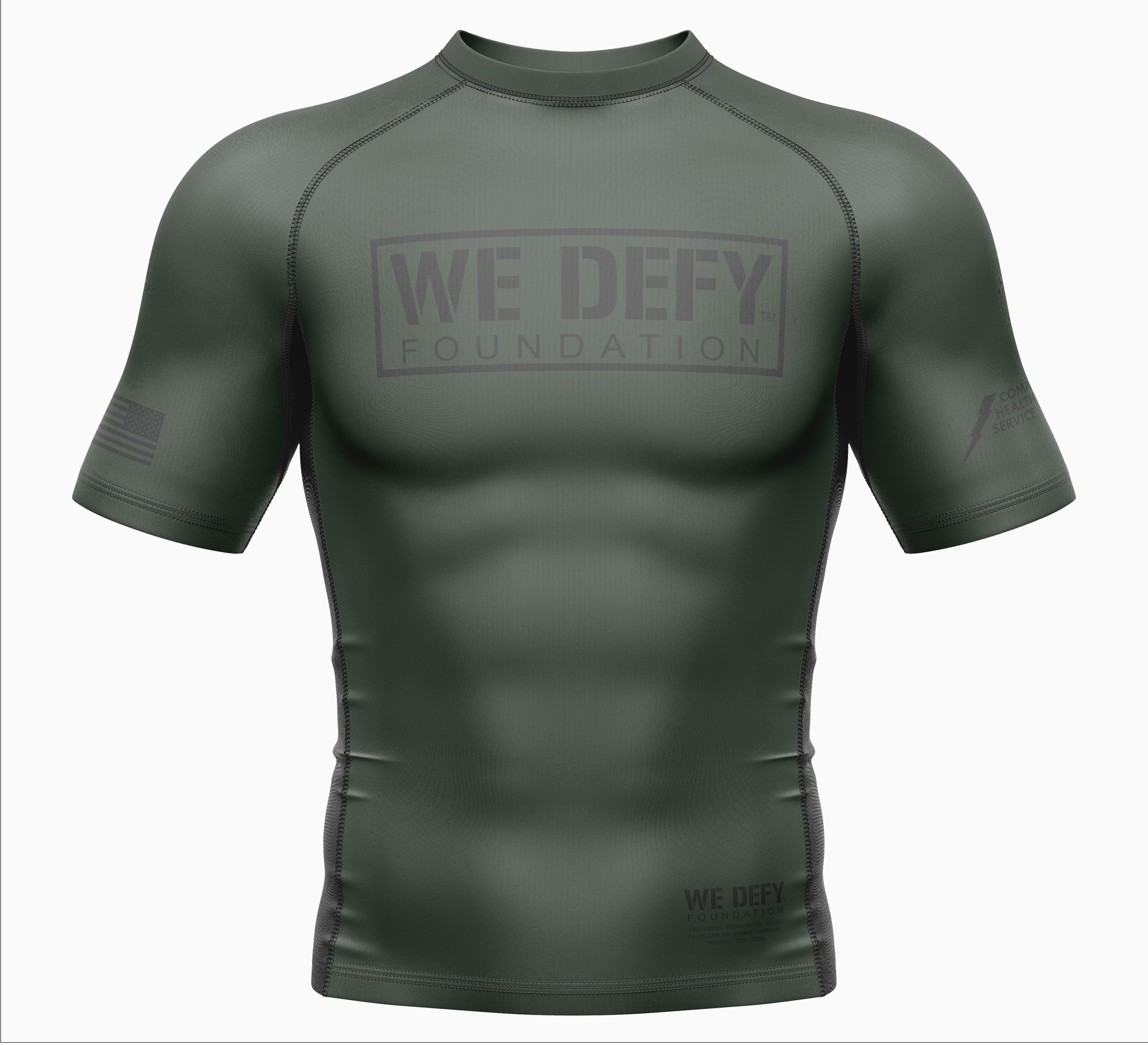 The We Defy Core Rashguard is a green, tight-fitting, short-sleeve athletic shirt featuring “WE DEFY FOUNDATION” on the chest, subtle sleeve and front logos, and black seam stitching.