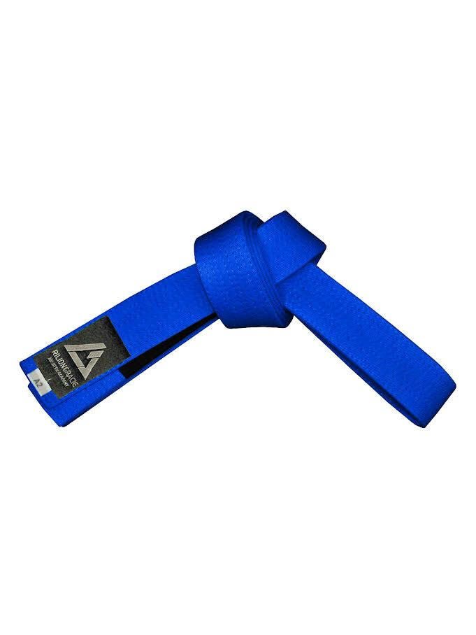 The Rilion Gracie Belt Royal Blue is tied in a knot, featuring a black label with a triangular logo and text on one end, set against a white background.