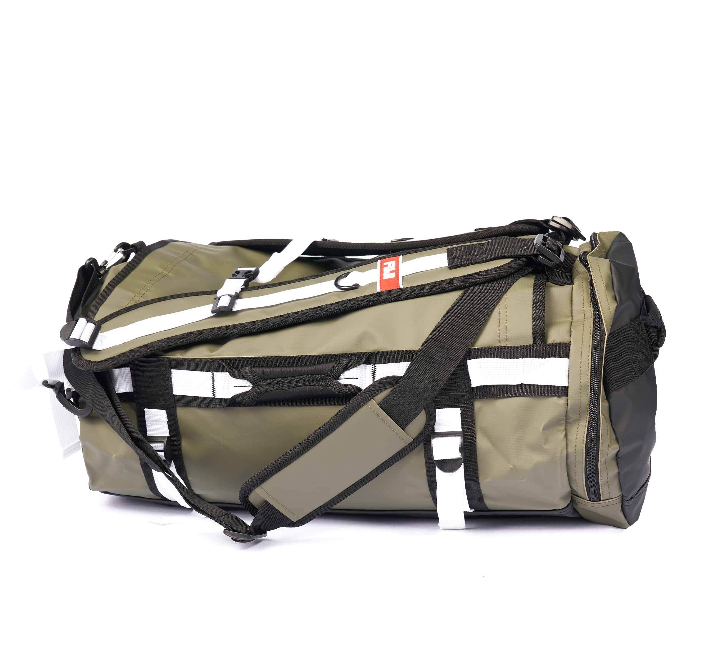 Army green Comp Convertible Backpack Duffle featuring multiple straps, handles, and buckles with white accents, displayed against a plain white background.